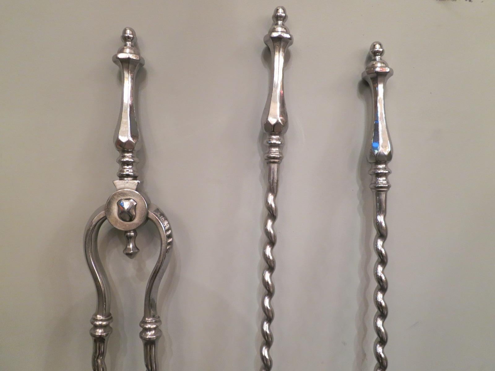 A set of tools in polished steel with barley twist design. English 19th century.
