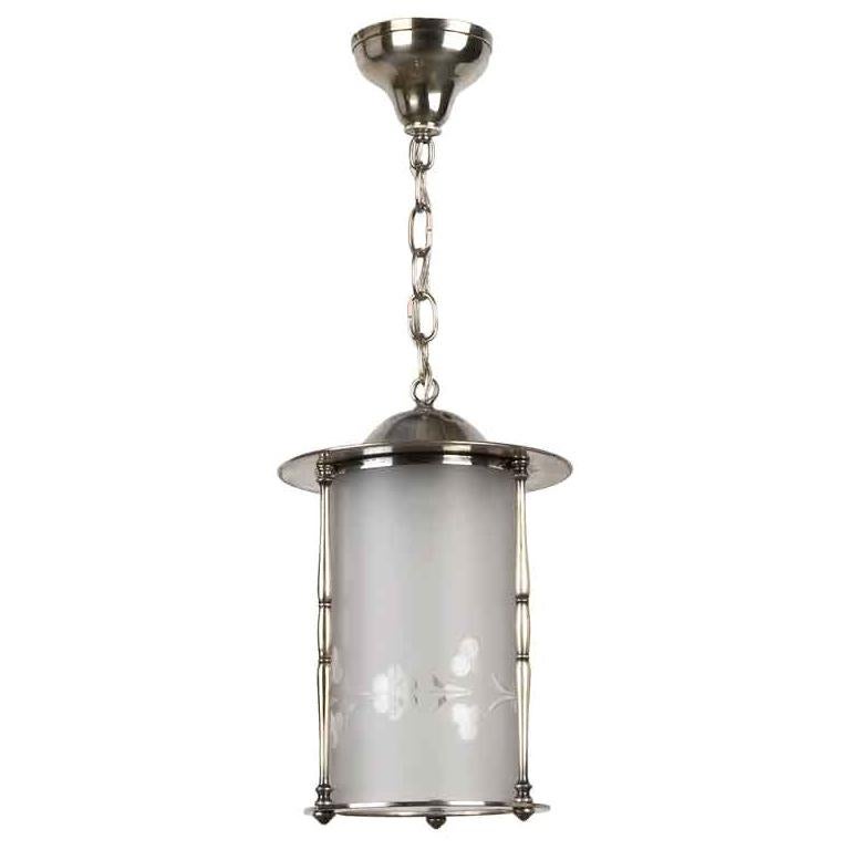 AHL3597
A silverplate lantern having a cylindrical frosted and wheel-cut relief glass lens with a foliate pattern. Due to the antique nature of this fixture there may be nicks or imperfections in the glass.

Dimensions:
Current height:
