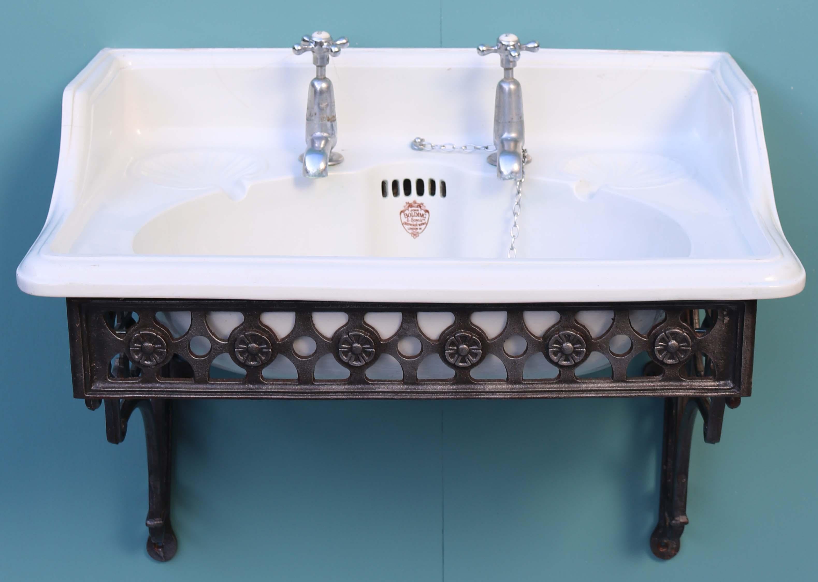 A reclaimed antique sink with a burnished wall mounted cast iron wall bracket.

Condition report

Good structural condition. The taps turn, however they are not tested. There are several hairline cracks to the up-stand or splash back at the back