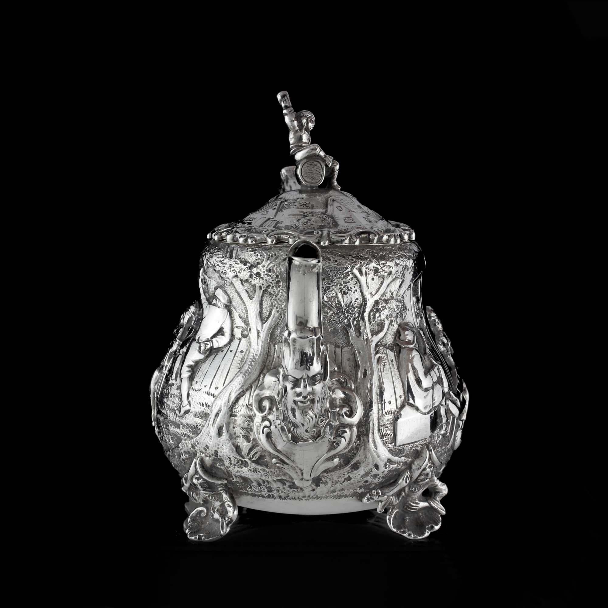 An Antique late Victorian sterling silver bachelor teapot with engravings inspired by David Teniers. David Teniers was a Dutch Baroque painter (1610-1690).  He was an innovator in a wide range of genres. Teniers is particularly known for developing