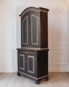 An antique Swedish two-piece cupboard in black and grey