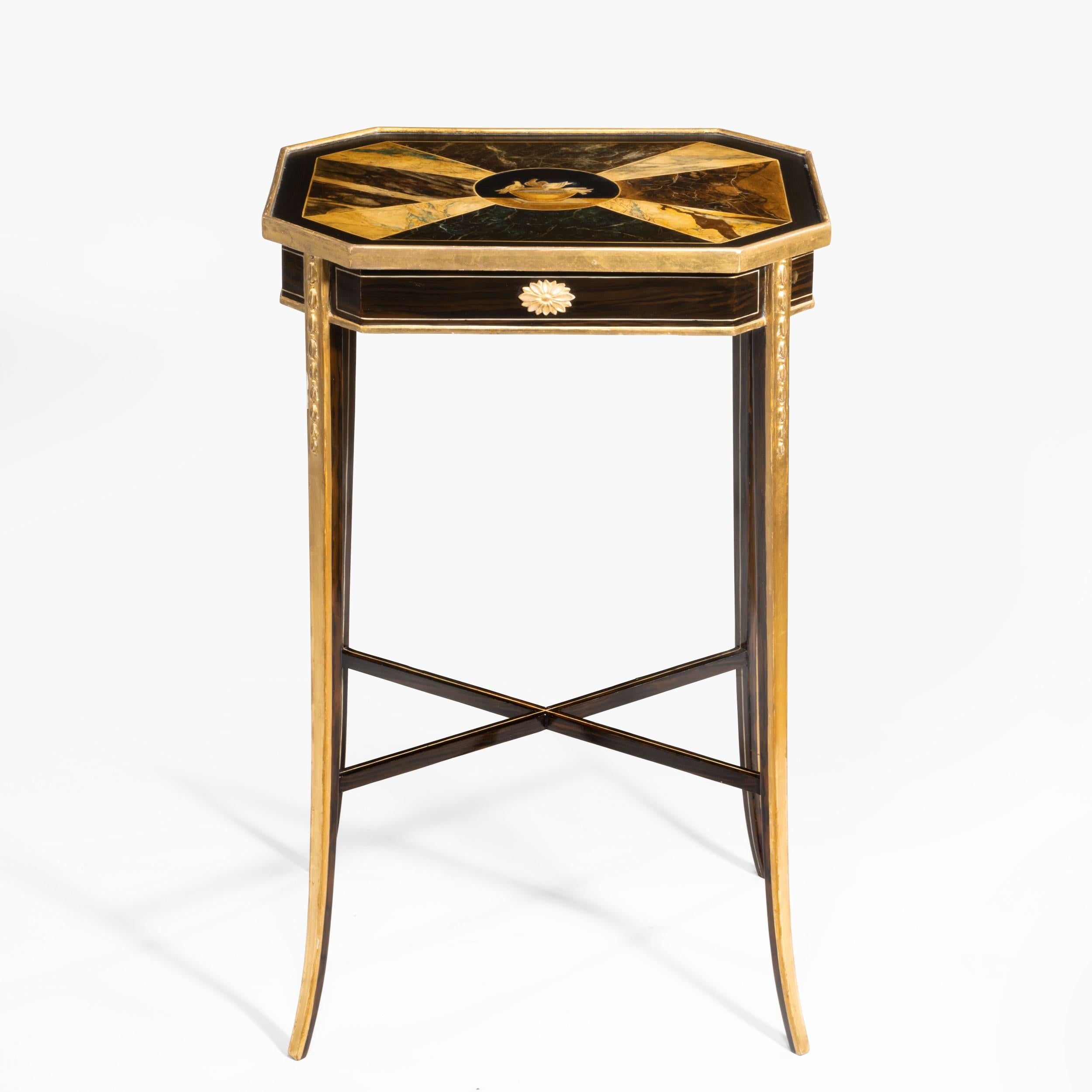 A fine trompe l'Œil painted occasional table

The top, of octagonal form, painted in imitation of costly specimen marbles, with a central motif depicting the Doves of Pliny. The slender tapering legs having carved giltwood decoration and a