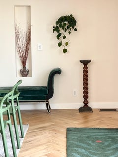 An antique turn wood pedestal with carved metal detail, early 20th century