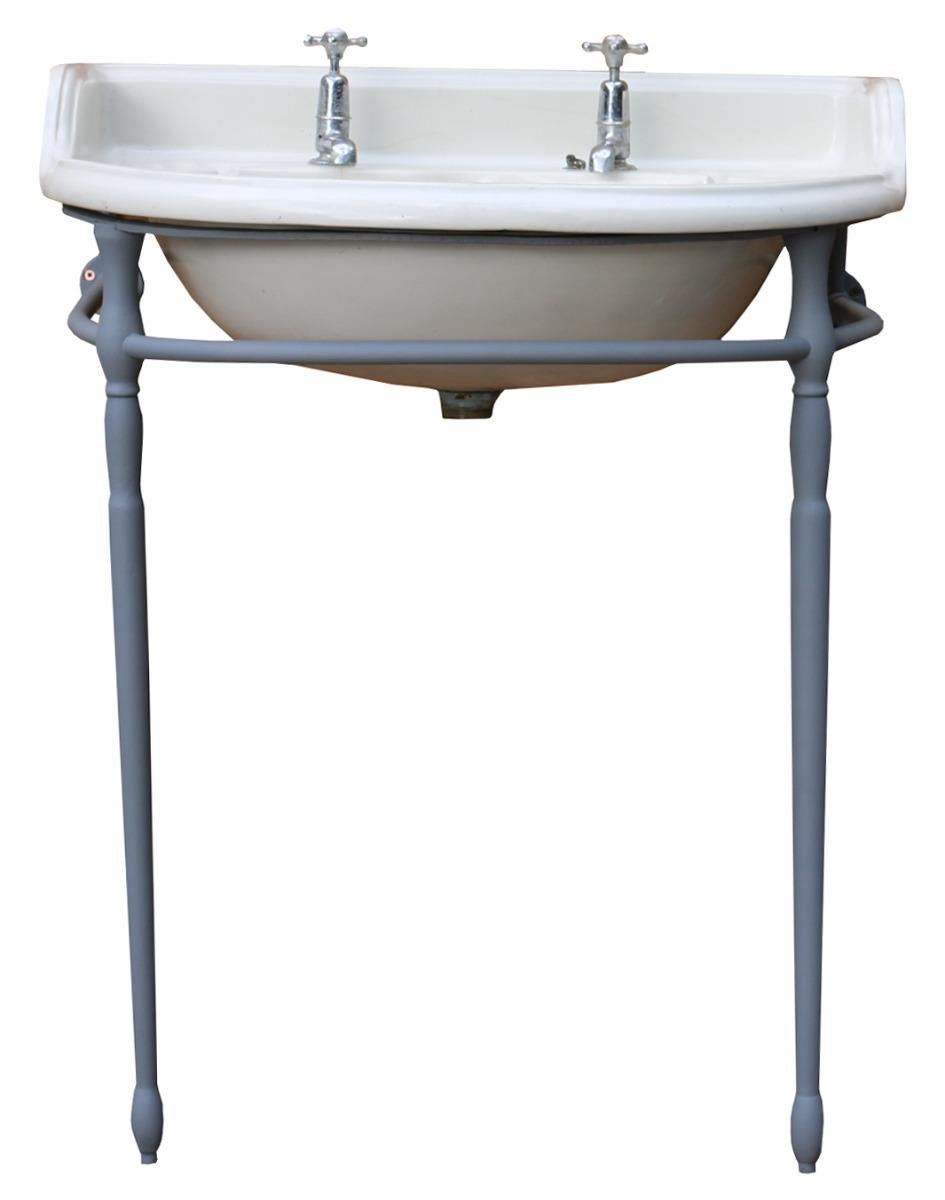 A late Victorian period porcelain basin with cast iron and timber floor standing bracket. The taps are included. The bracket has been finished in a grey primer.