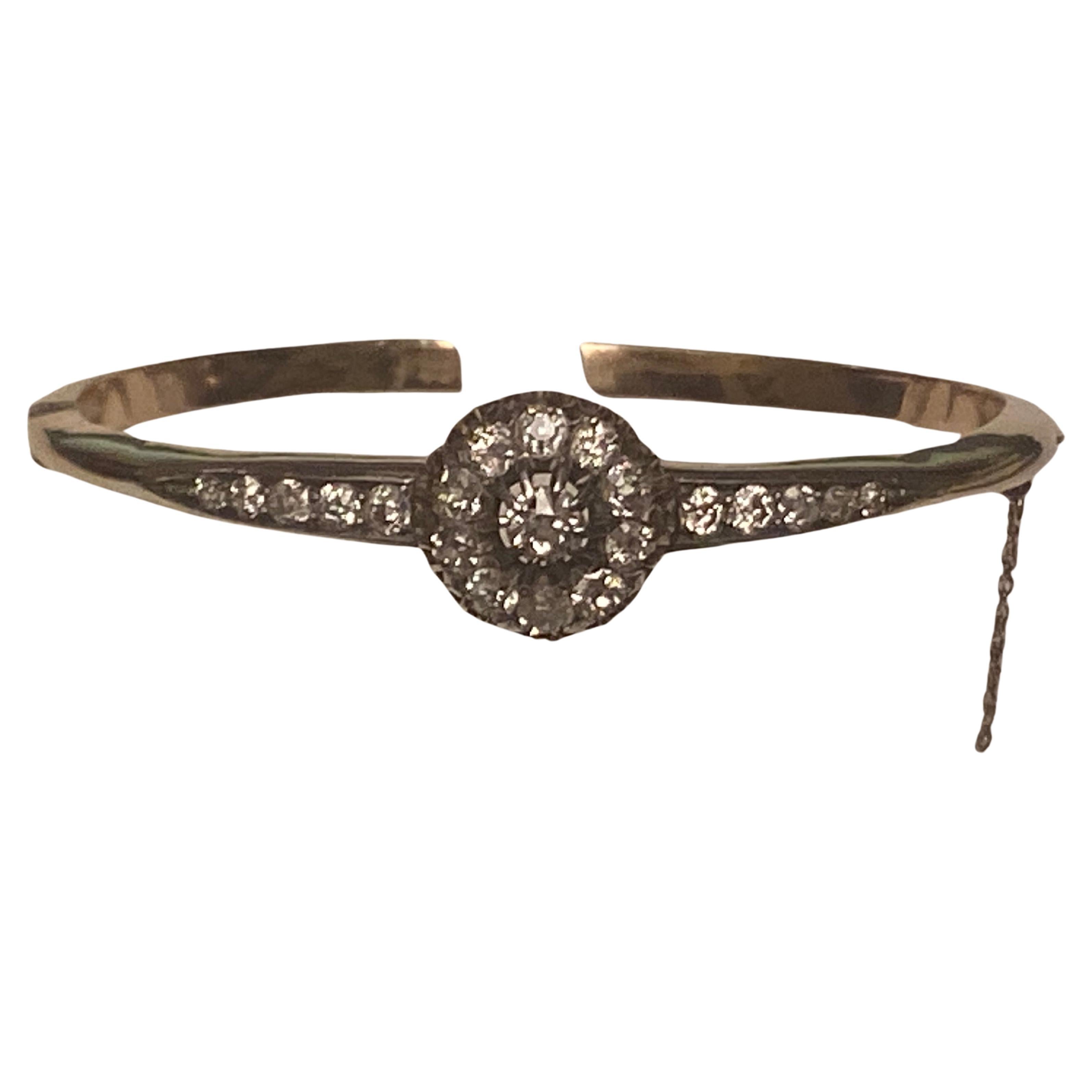 Antique Victorian gold and European old cut diamond cluster bangle which is in magnificent condition and looks lovely when worn.

An amazing piece set with twenty-one, glistening, graduated, old cut diamonds in each shoulder which leads to a raised,