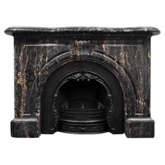 An antique Victorian period fireplace made from Portoro Nero marble