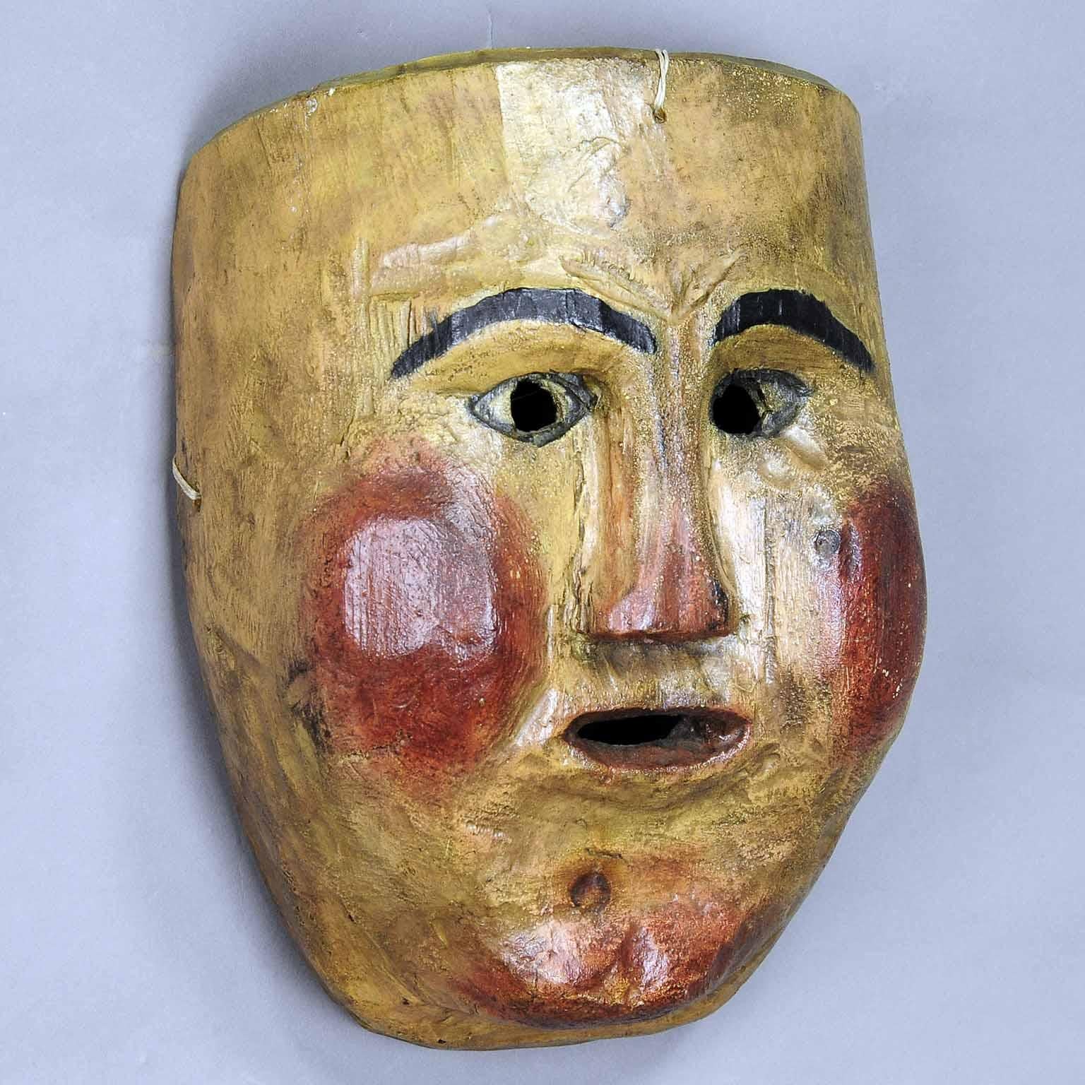 An antique wooden carved carnival mask from the region of South Tyrol. these masks are used in Austria, South Germany and Italy at the carnival “Fasnacht” processions to chase away winter. Hand carved pine wood, hand painted, first half of the 20th