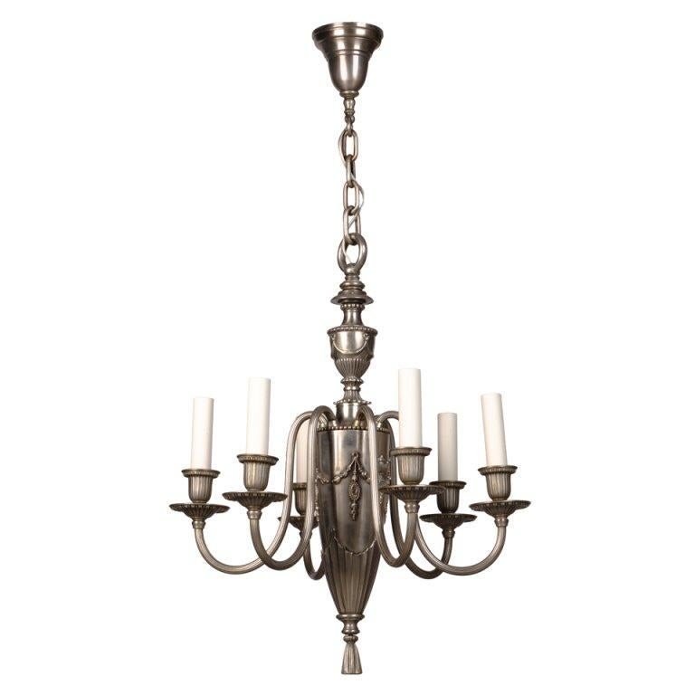 AHL3729
An antique nickeled brass Adam style six light chandelier with narrow arms and bullet shaped body. By the Connecticut maker Bradley and Hubbard.

Dimensions:
Current height: 41-1/4
