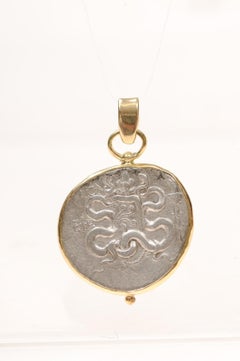 An AR Tetradrachm Cista Mystica Pendant with 18 Karat Gold (pendant only)