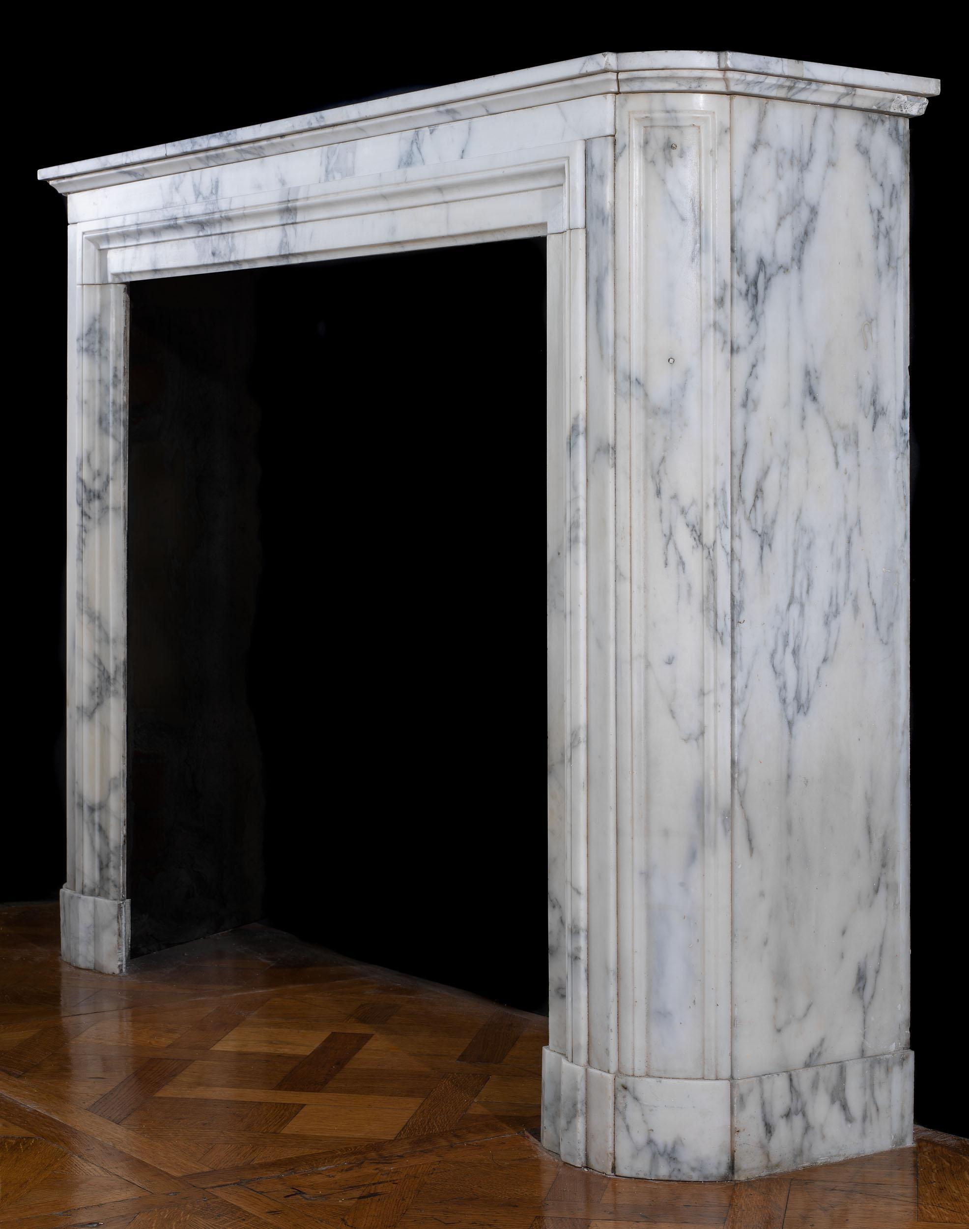 A Louis XVI antique chimneypiece in softly veined Arabascato Marble. Charming in its simplicity. The moulded shelf, above a bolection style opening, is supported by angled, panelled jambs resting on sectioned footblocks.
French, early 19th century.