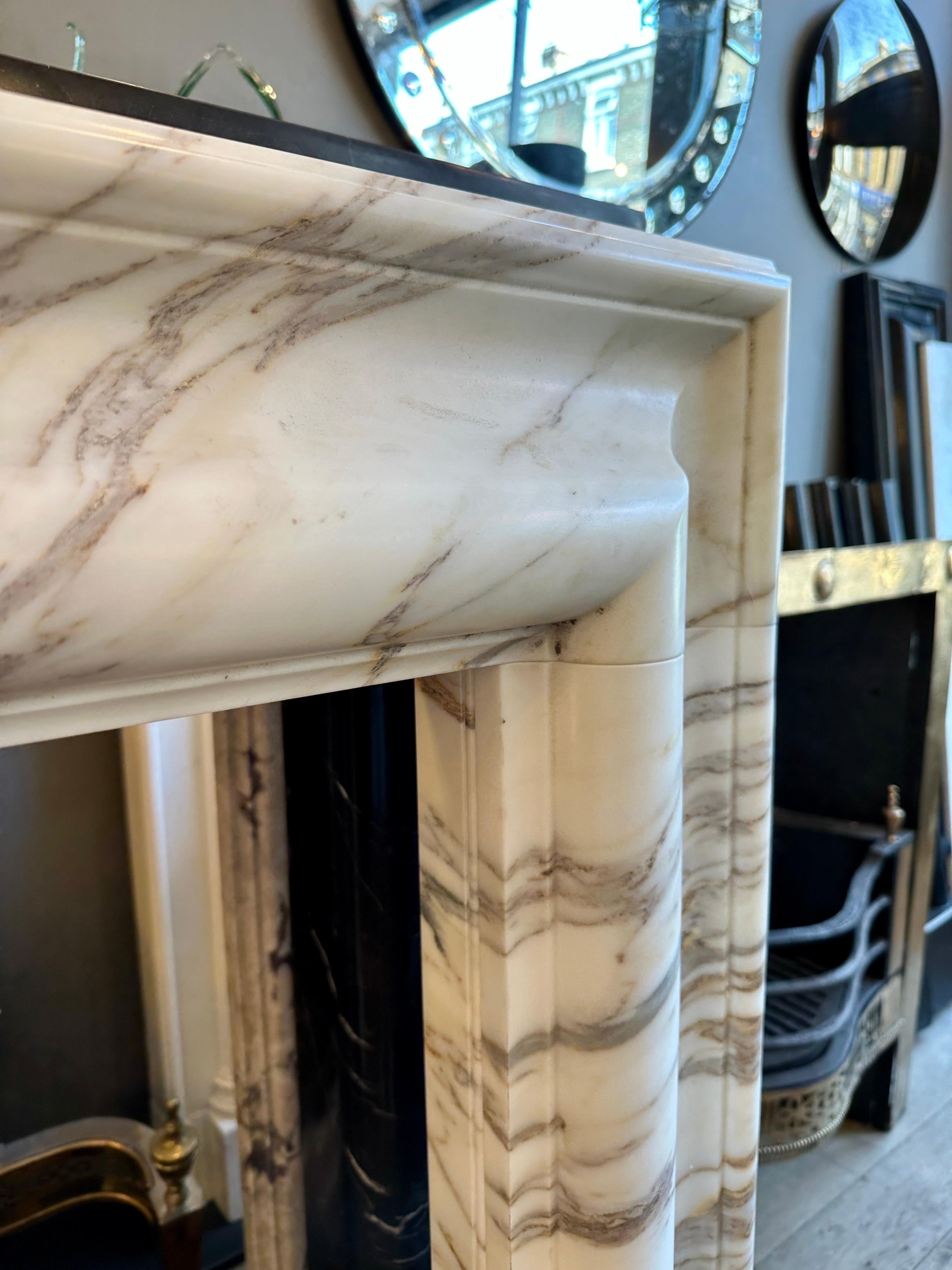 Hand-Carved An Arabescato Marble Bolection Fireplace Mantle  For Sale