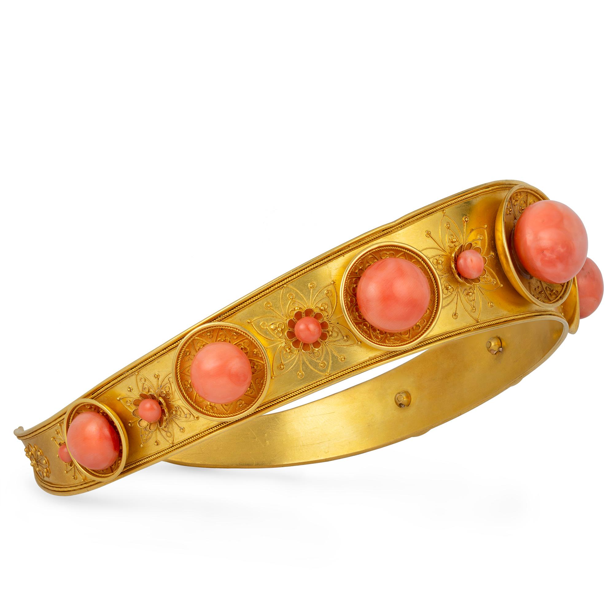 An archaeological-revival coral and gold Spartan diadem, in the form of a gold band with seven concave discs each set with a cabochon coral, alternating with eight floral motifs each set with a small cabochon coral, all with gold wirework