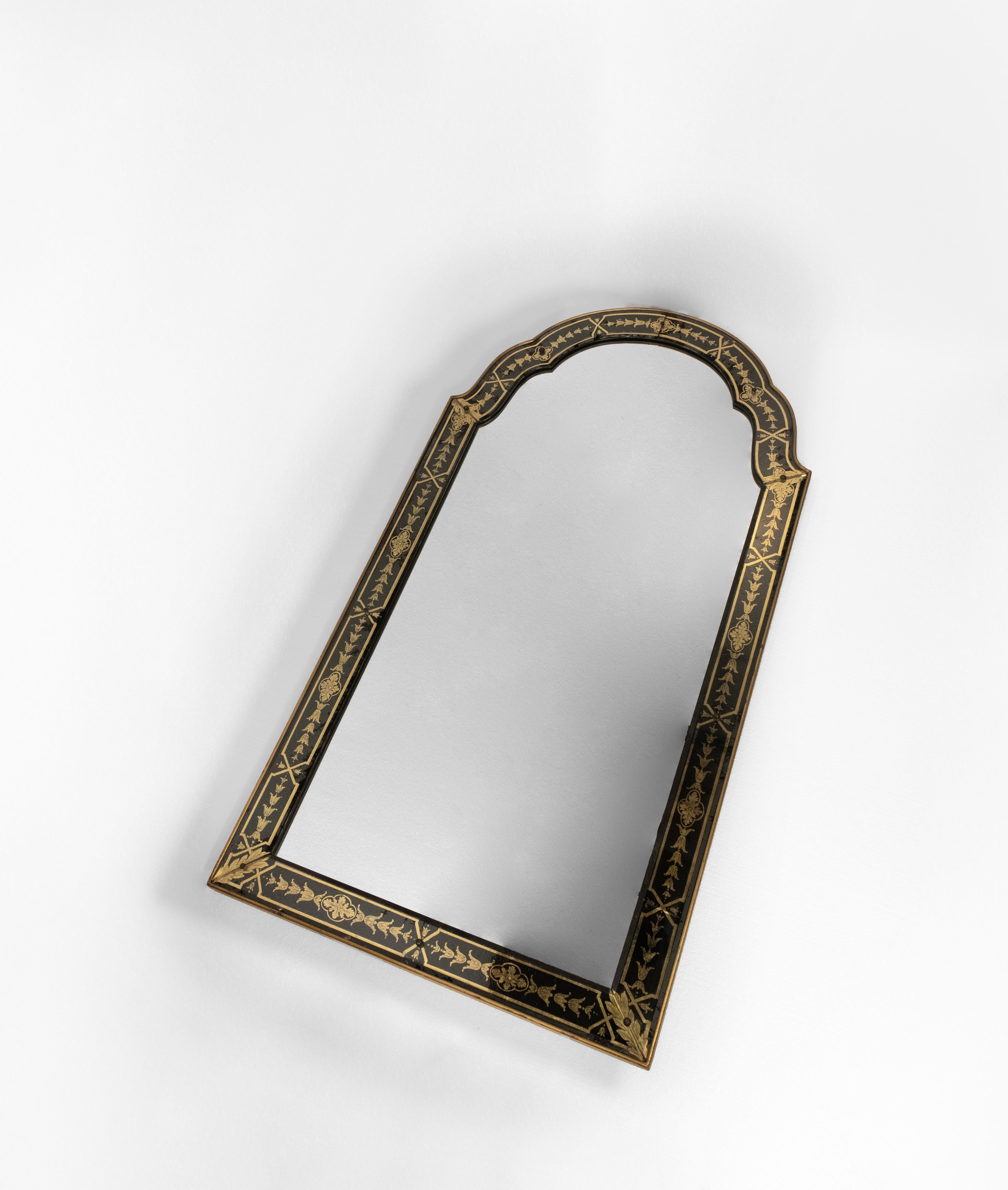 This is an American mirror with an arched top and a striking reverse-painted glass frame. The glass sections are adorned with intricate gold detailing on a black background, showcasing highly detailed bellflower and crossband motifs. The frame is