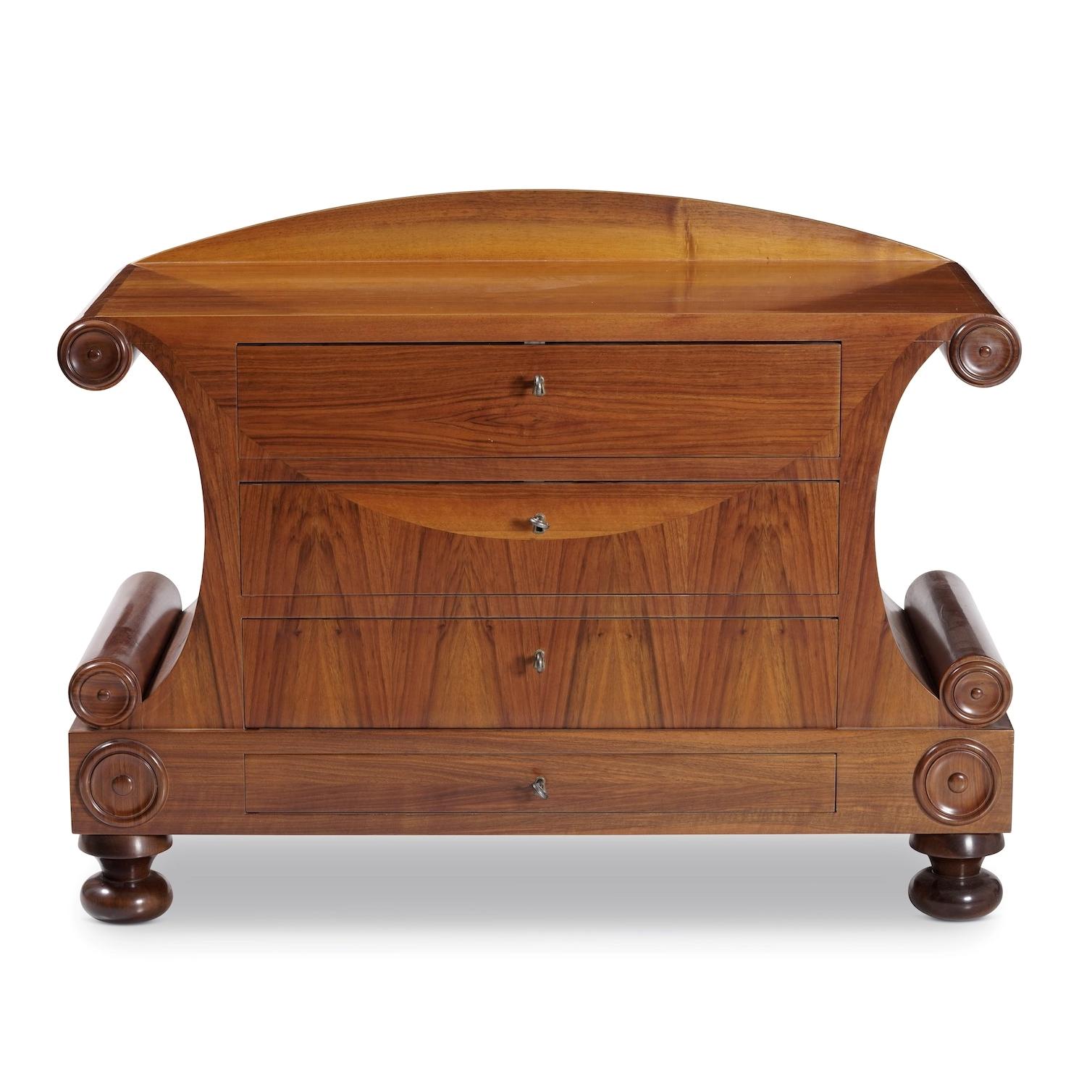 Austria, circa 1840

A rare early nineteenth century Biedermeier commode, of architectural form with finely figured book matched veneers of cherry wood to the front, opening with three drawers, with bold scrolled and scalloped ends, with stylised