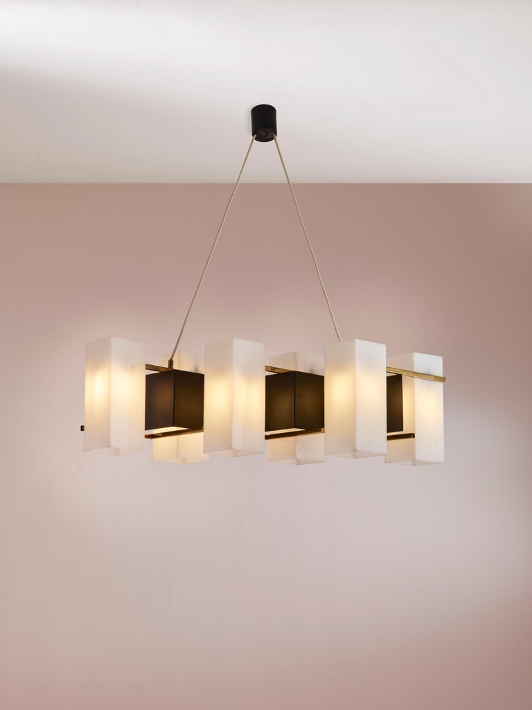 An architectural chandelier made in brass lucite and metal by Stilux