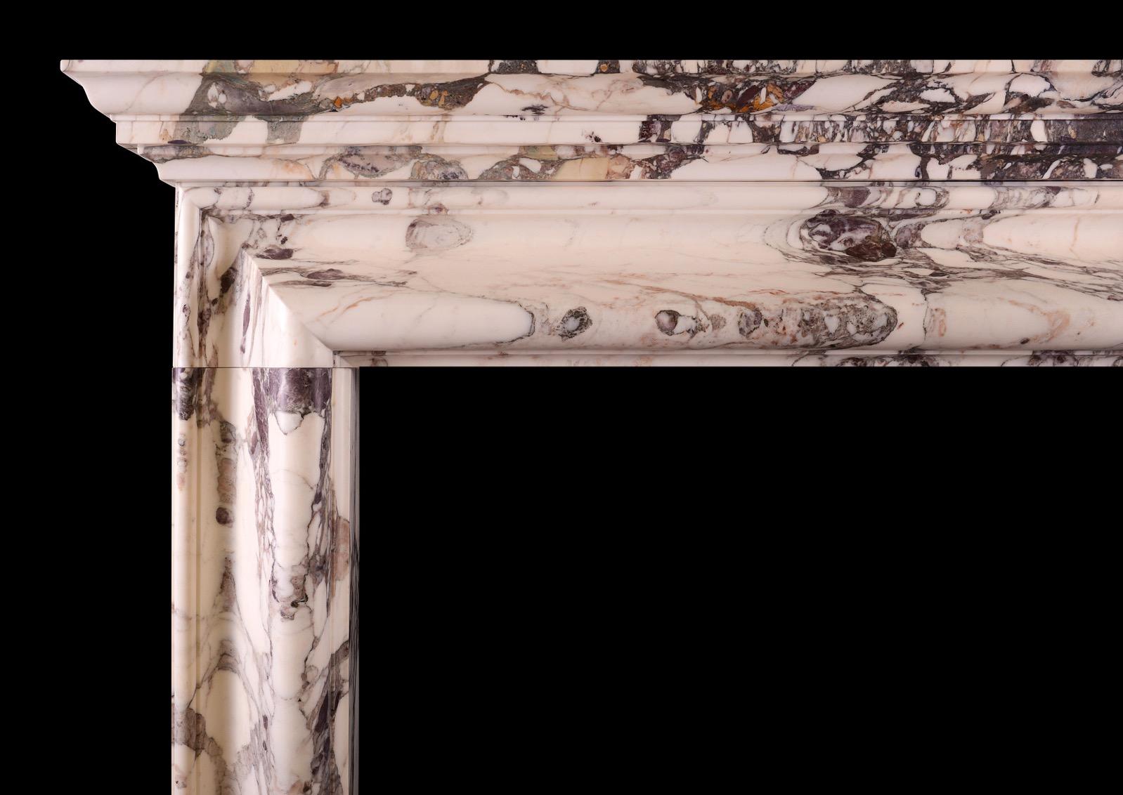An English bolection fireplace with moulded shelf above. Shown in Breche Violette marble, also available in white marble and Italian Arabescato marble and could be made in other marbles or limestones if required. English, modern. N.B. May be subject