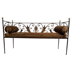An architectural hand-forged wrought iron hallway bench