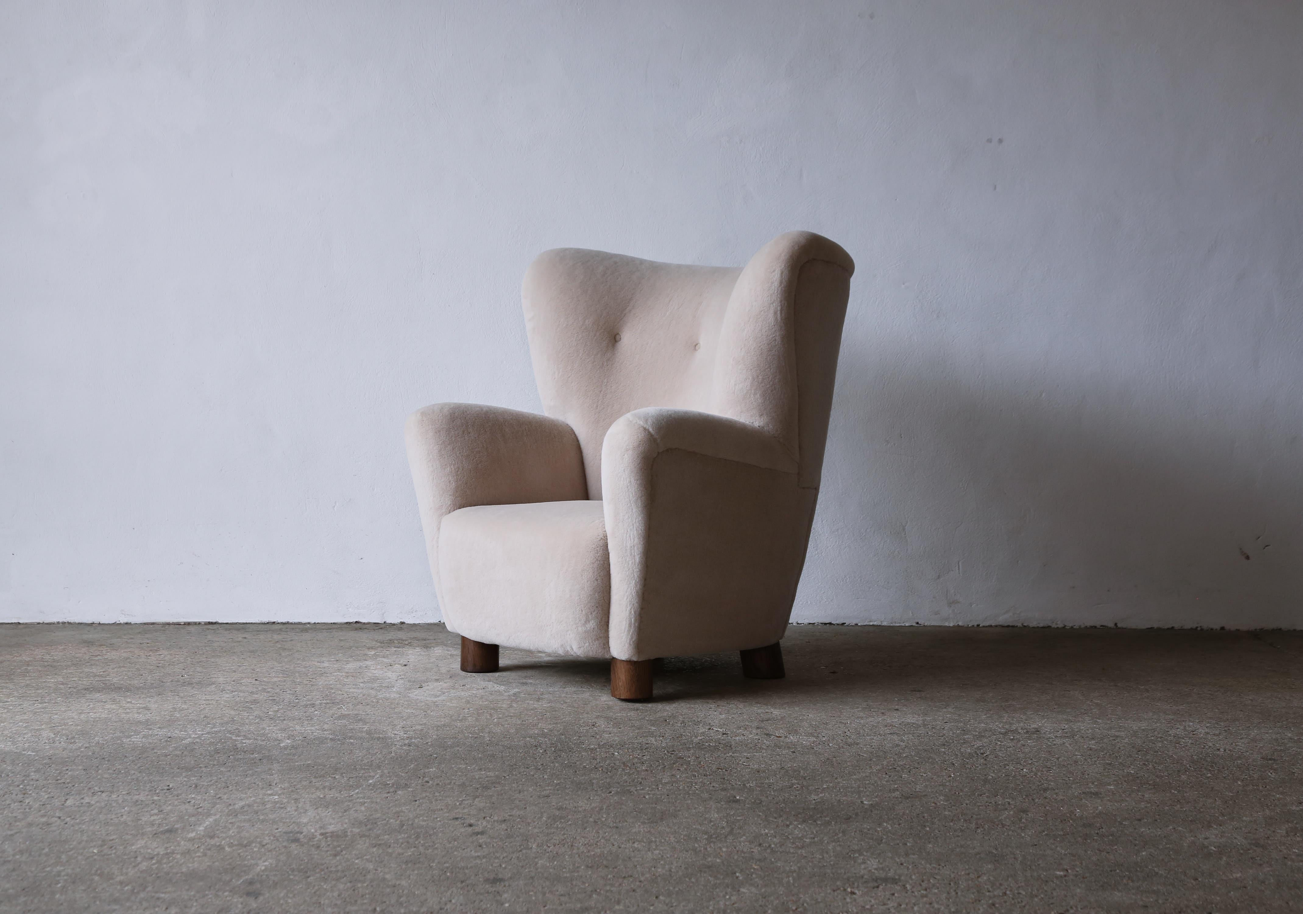 A lovely armchair, Denmark, 1950s. Newly upholstered in a luxurious, soft, ivory pure alpaca wool. Fast shipping worldwide.
 


