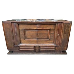 An Art Deco 1940s oak sideboard by Gaston Poisson with original marble top.