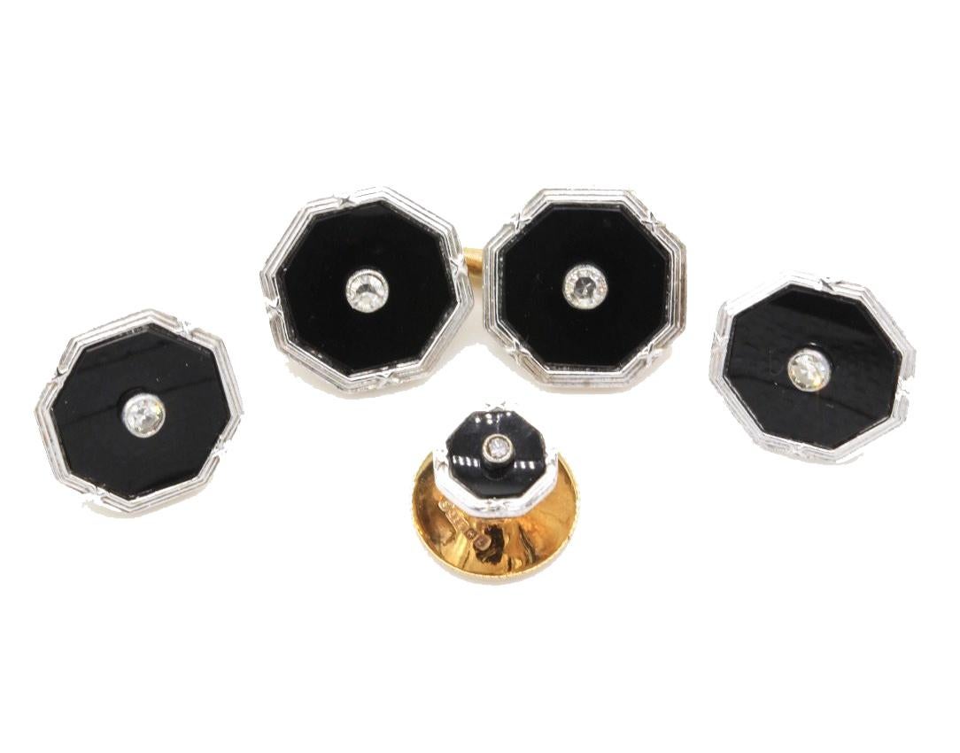 An Art Deco 9 Kt yellow and white gold Gentleman's tuxedo dress set, comprising a pair of cufflinks, four buttons and two collar studs The octagonal 12 mm chain linked cufflinks and buttons in black onyx, edged in white gold and with a central
