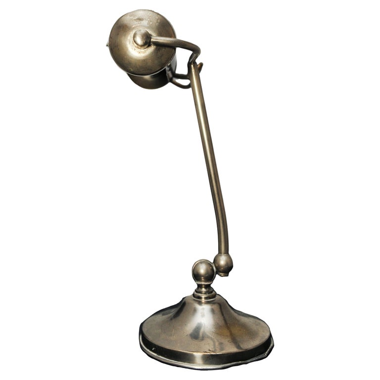 An Art Deco Adjustable Chrome Bankers Desk Lamp, on a circular