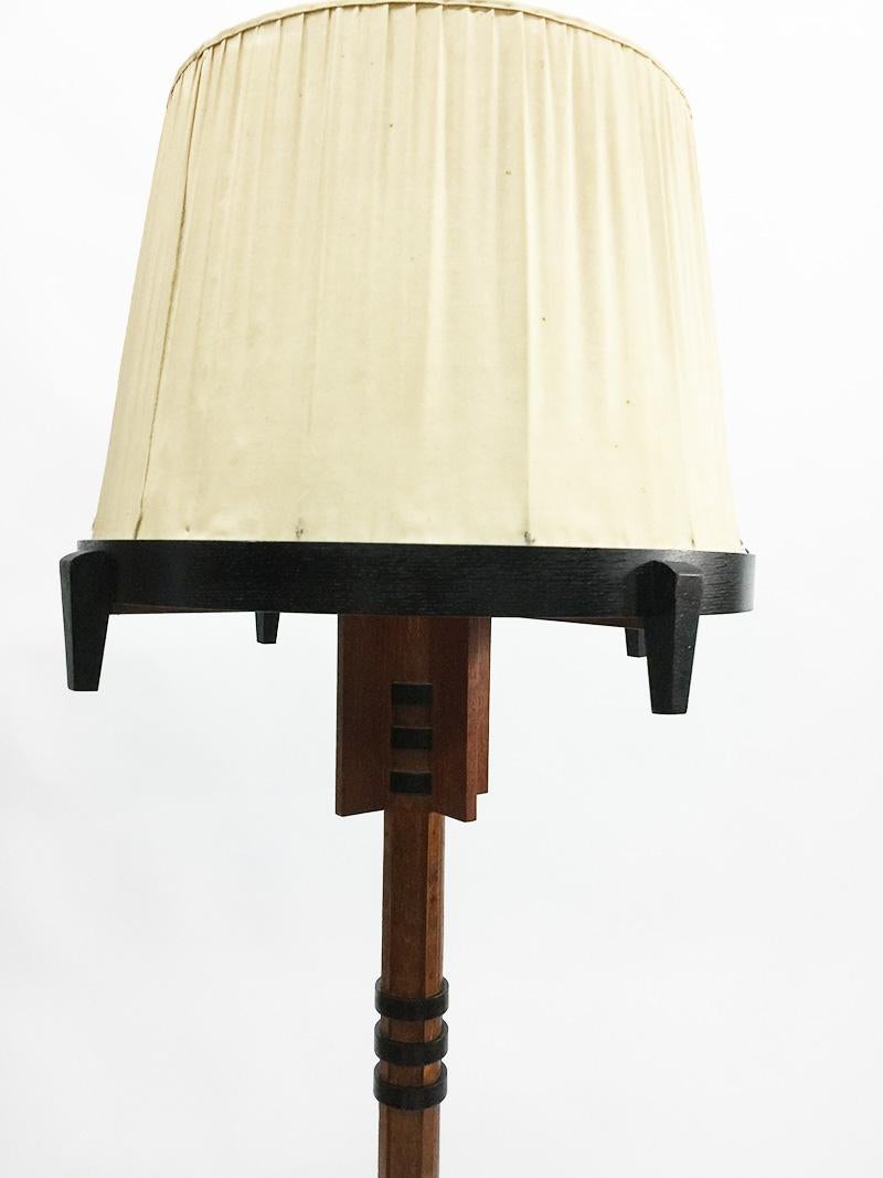 A Dutch Art Deco Amsterdam School style floor lamp, 1910-1920

An Art Deco Amsterdam School style floor lamp made of oak with blackened wooden ornaments. 
The electrical wire goes through the bottom of the foot
Dutch Art Deco 1910-1920 in the style