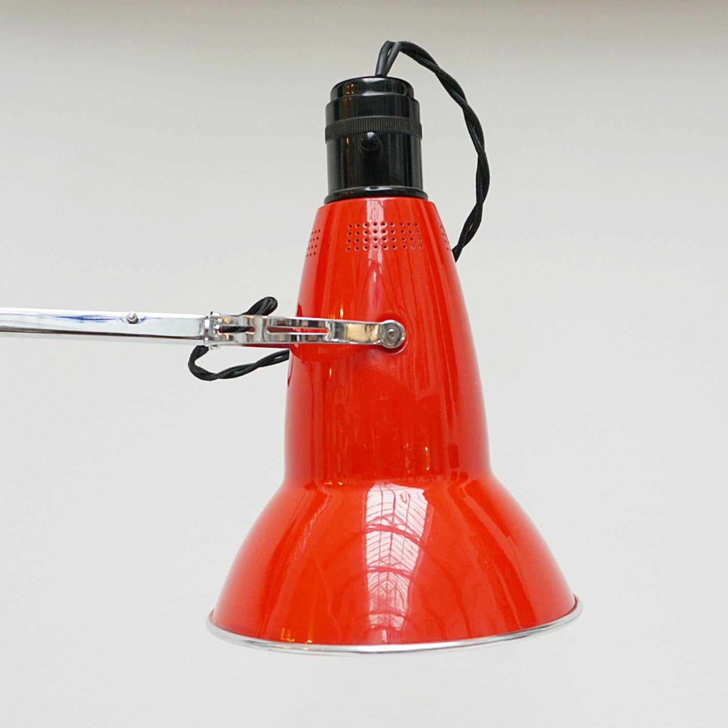 'Three-spring' 1930's prototype Anglepoise desk lamp by Herbert Terry & Sons. Chrome arm assembly with matching red two step base and perforated lamp shade. Original stamps to stem. The three spring Anglepoise lamp was first released by Herbert