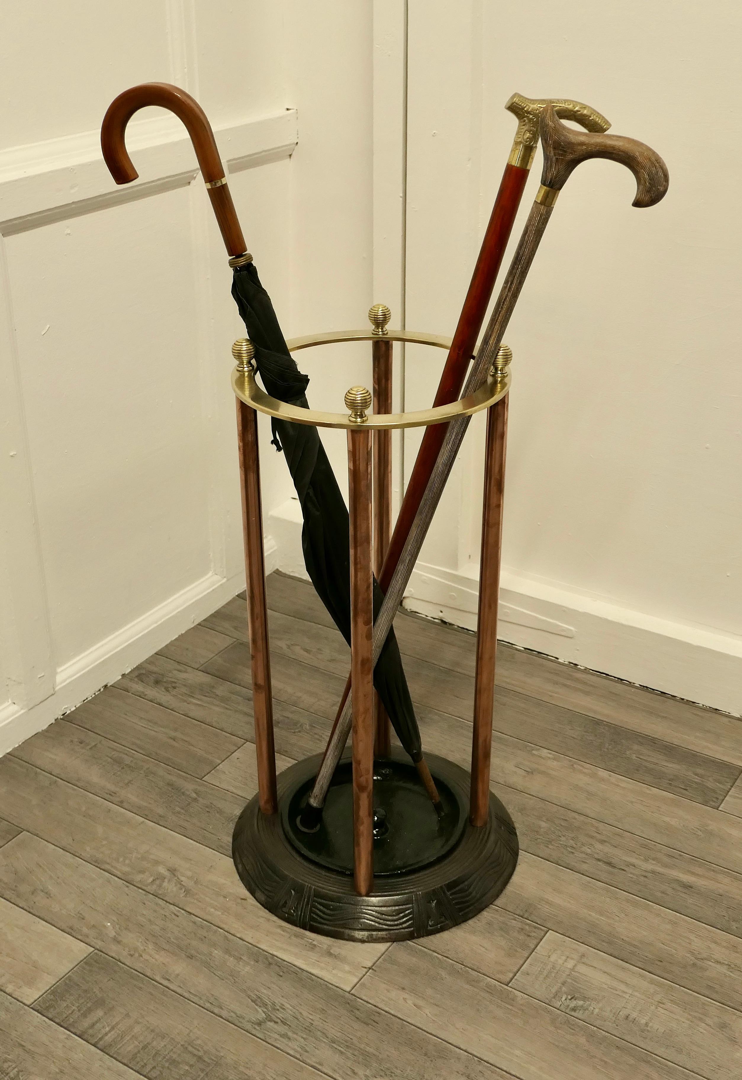 An Art Deco brass and cast iron Nautical stick or umbrella stand

A very Stylish piece, the stand sits neatly in a small space the round base has a nautical decoration of waves and anchors, very useful where space is scarce. It has a brass rail
