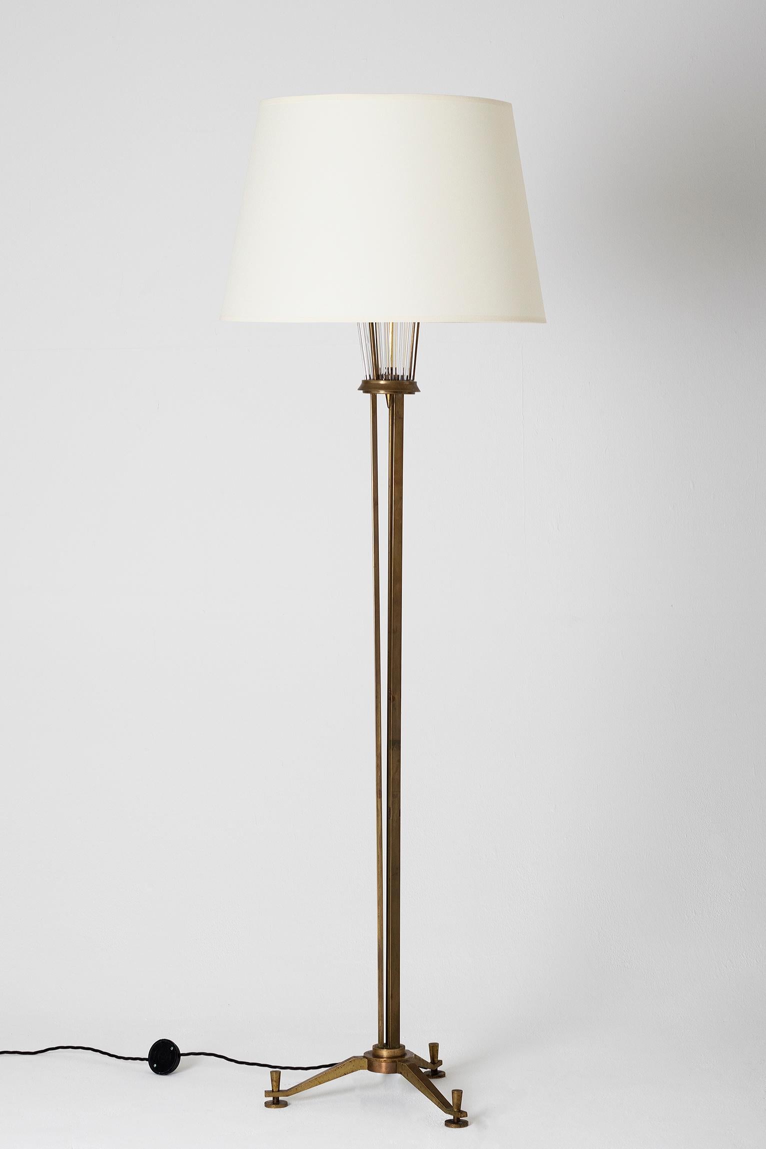 A brass and glass rods floor lamp, by Henri Petitot for Atelier Petitot
France, Lyon, circa 1935
With the shade: 170 cm tall by 51 cm diameter
Lamp base only: 140 cm tall by 38 cm wide.