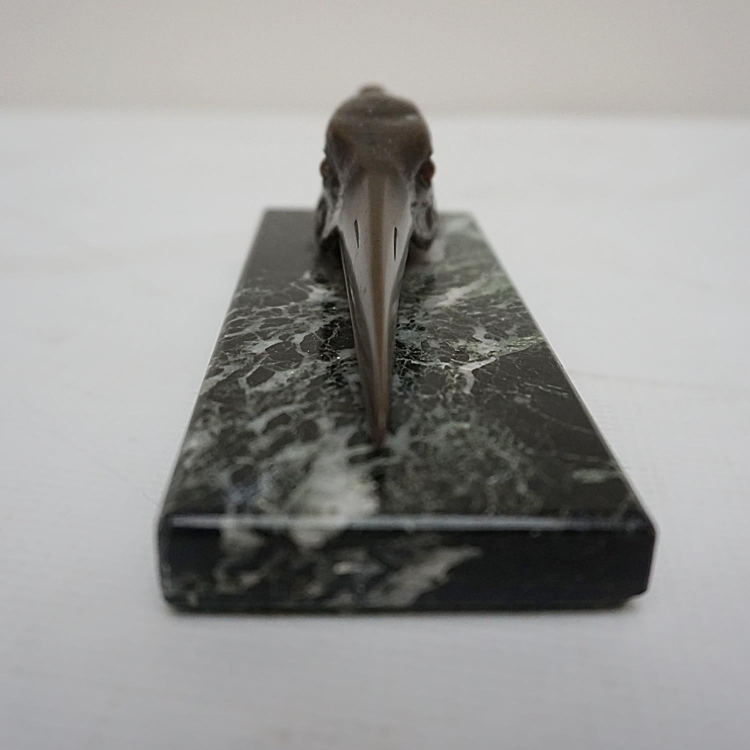 An Art Deco letter holder with a bronze stork head over a marble base. The beak opening to act as a letter holder. 

Dimensions: H 5.5cm W 14cm D 6cm

Origin: English

Date: Circa 1930

Item Number: 0811223
