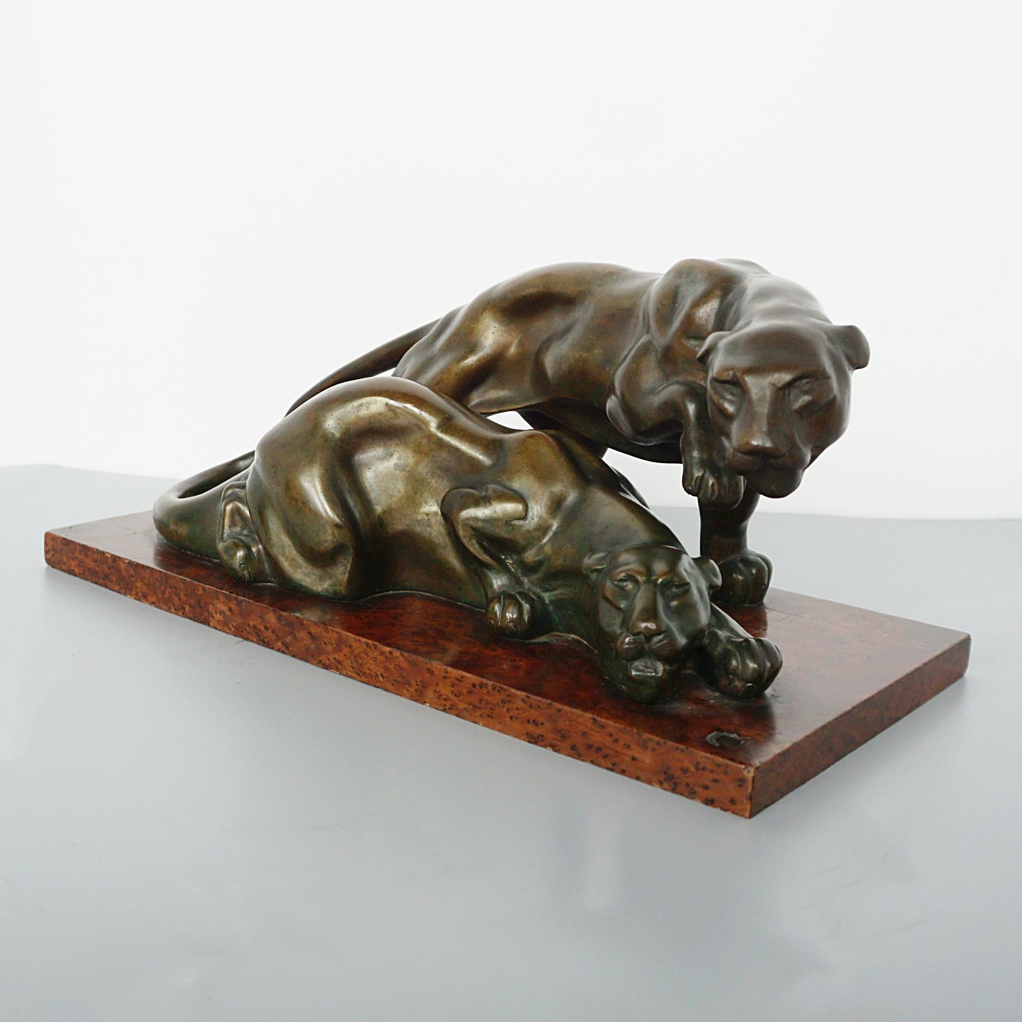 An Art Deco bronze sculpture depicting two prowling bronze panthers set over an original amboyna base. Attributed to Irénée Rochard with RR inscribed to base. 