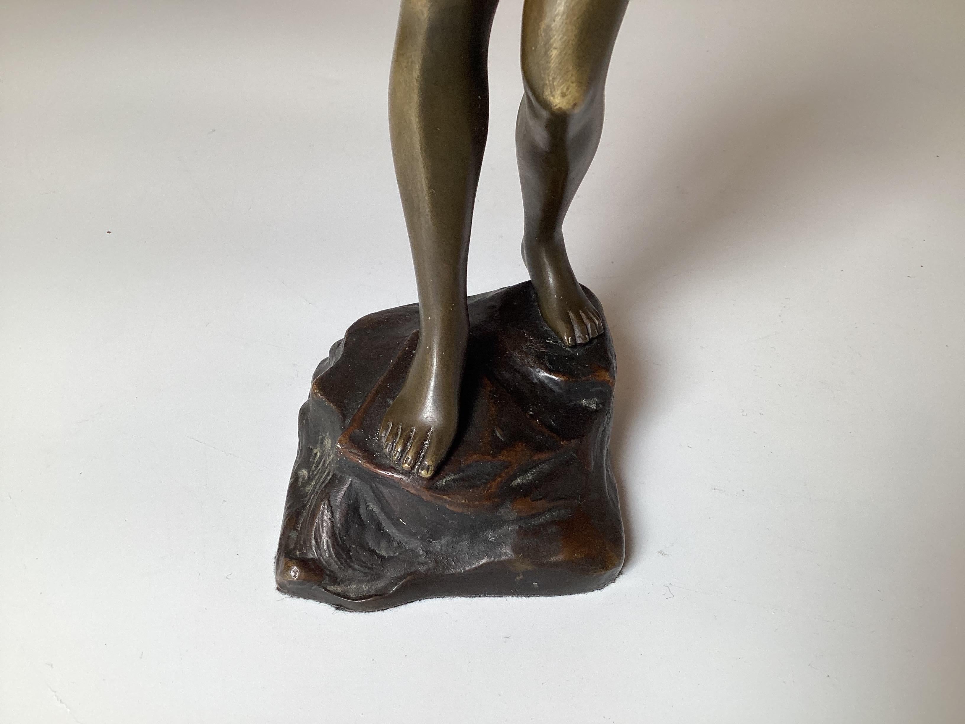 A fine cast bronze sculpture of a young woman holding a clam shell, signed on lower back Morath.  The bronze is with the original patination.  Stands 11 inches tall