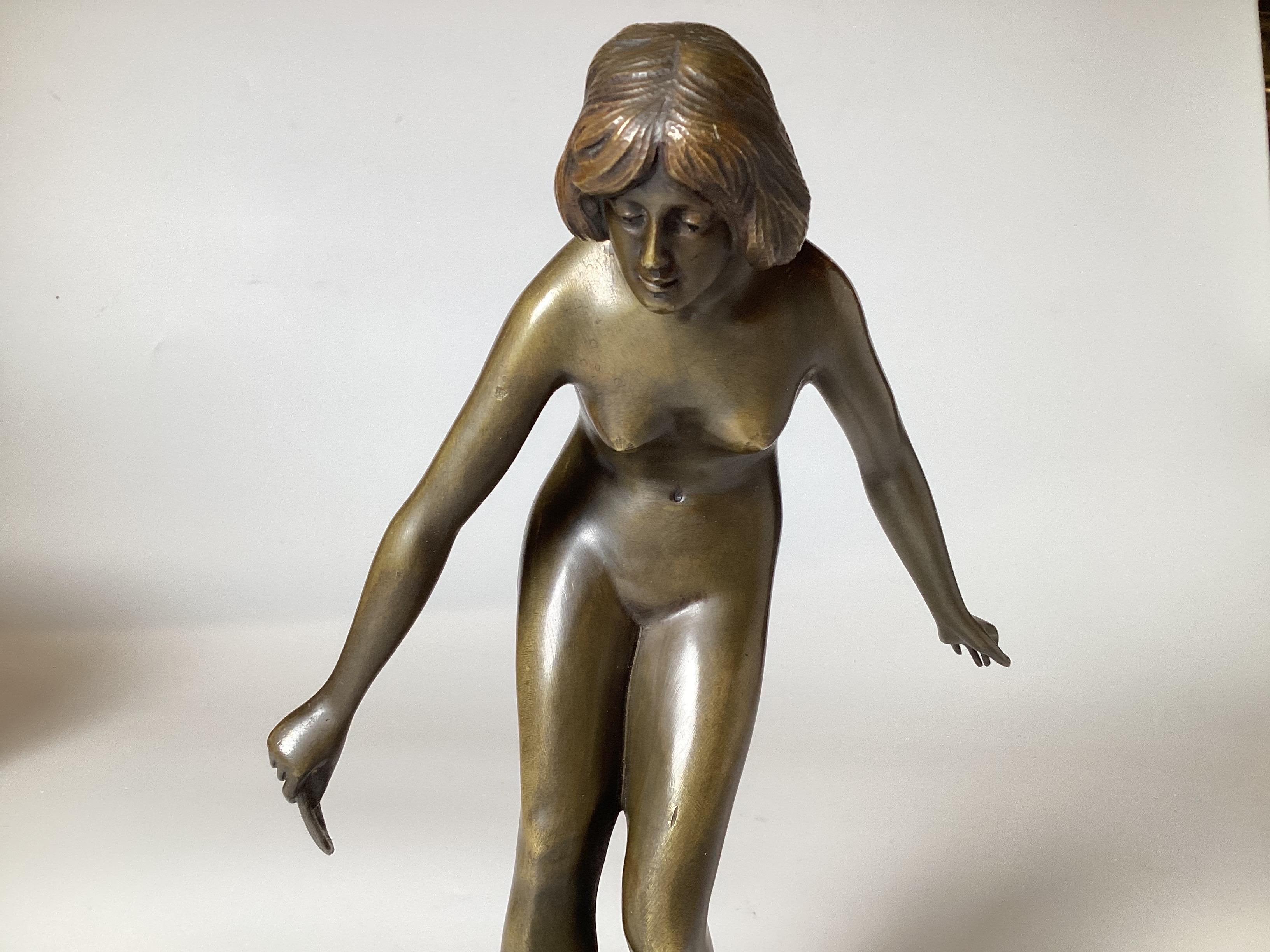 Patinated An Art Deco Bronze Sculpture of a Young Woman For Sale