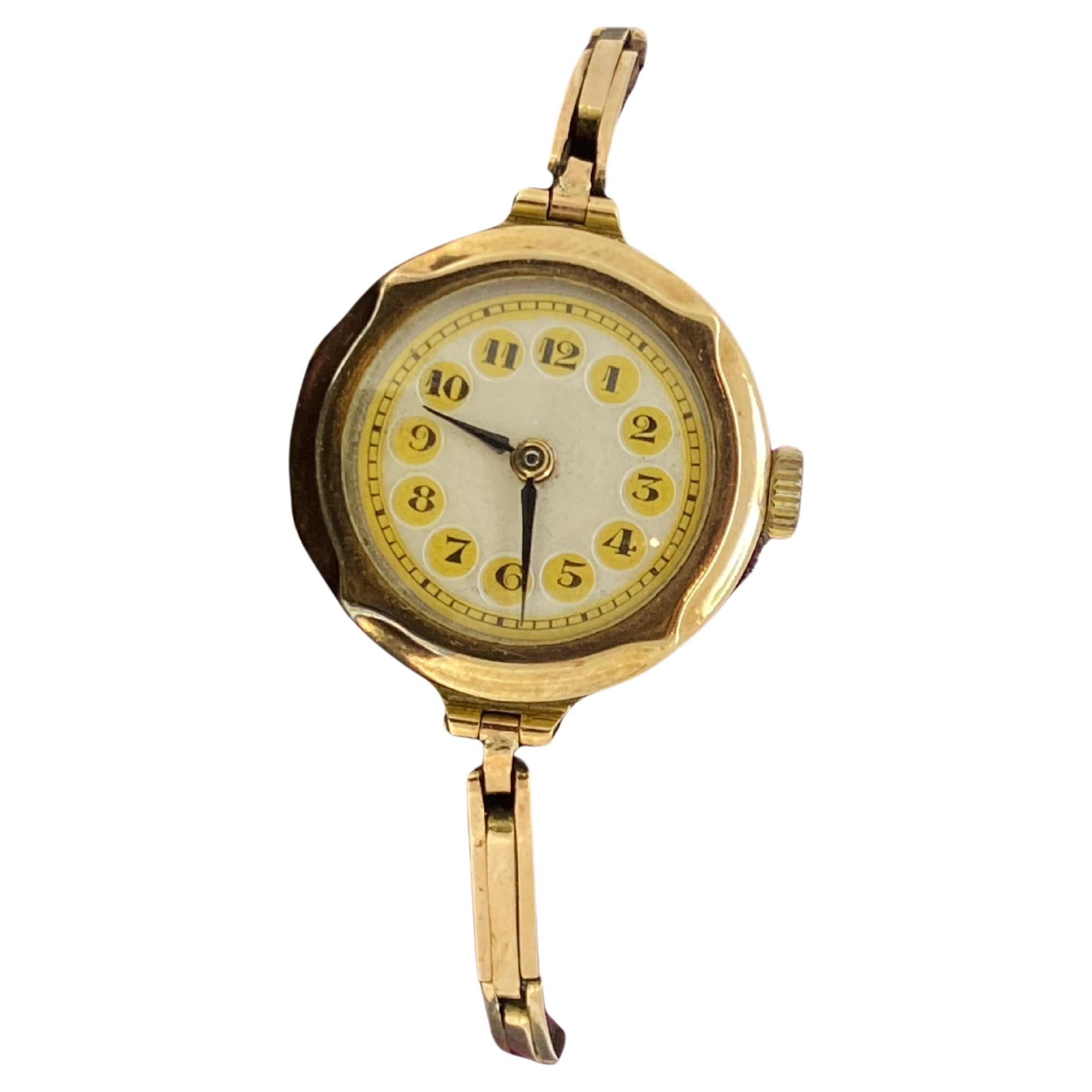 Fine & Rare Art-Deco circa 1924 
English Ladies’ Wristwatch features: 

Hinged Case is crafted in 9K Yellow Gold 
of unusual rounded hexagon shape 
measuring 25mm (not including winder) x 
28mm (from lug to lug), 

Caseback is stamped, numbered on