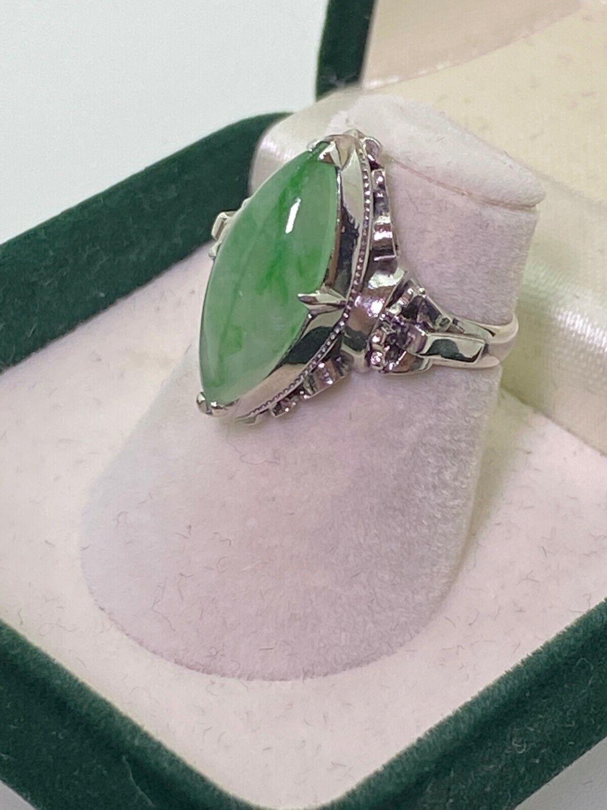 This Magnificent Piece of Jewellery 
is dating from Art-Deco period - circa 1930's & 
is in excellent condition despite its age. 

Centering a Natural Jadeite of 18mm x 8mm, 
of distinctive apple green colour
& marquise shape, 
securely set within