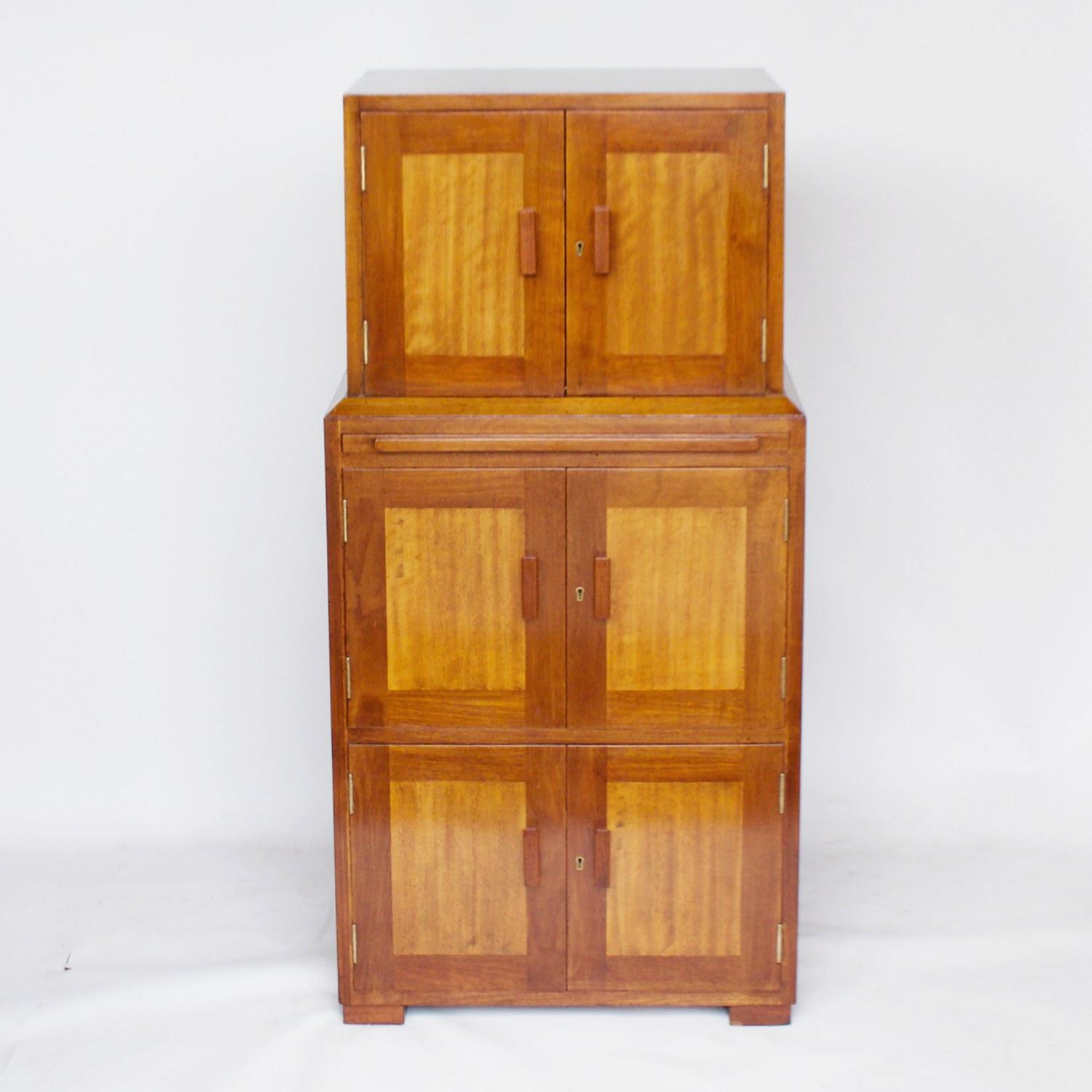 A well proportioned Art Deco cabinet by Betty Joel. Solid Australian Walnut. Drinks cupboard to top with a pull out shelf, above a middle magazine cabinet and a lower two door cabinet. 

Designer: Betty Joel (1894-1985)

Dimensions: H 118cm, W