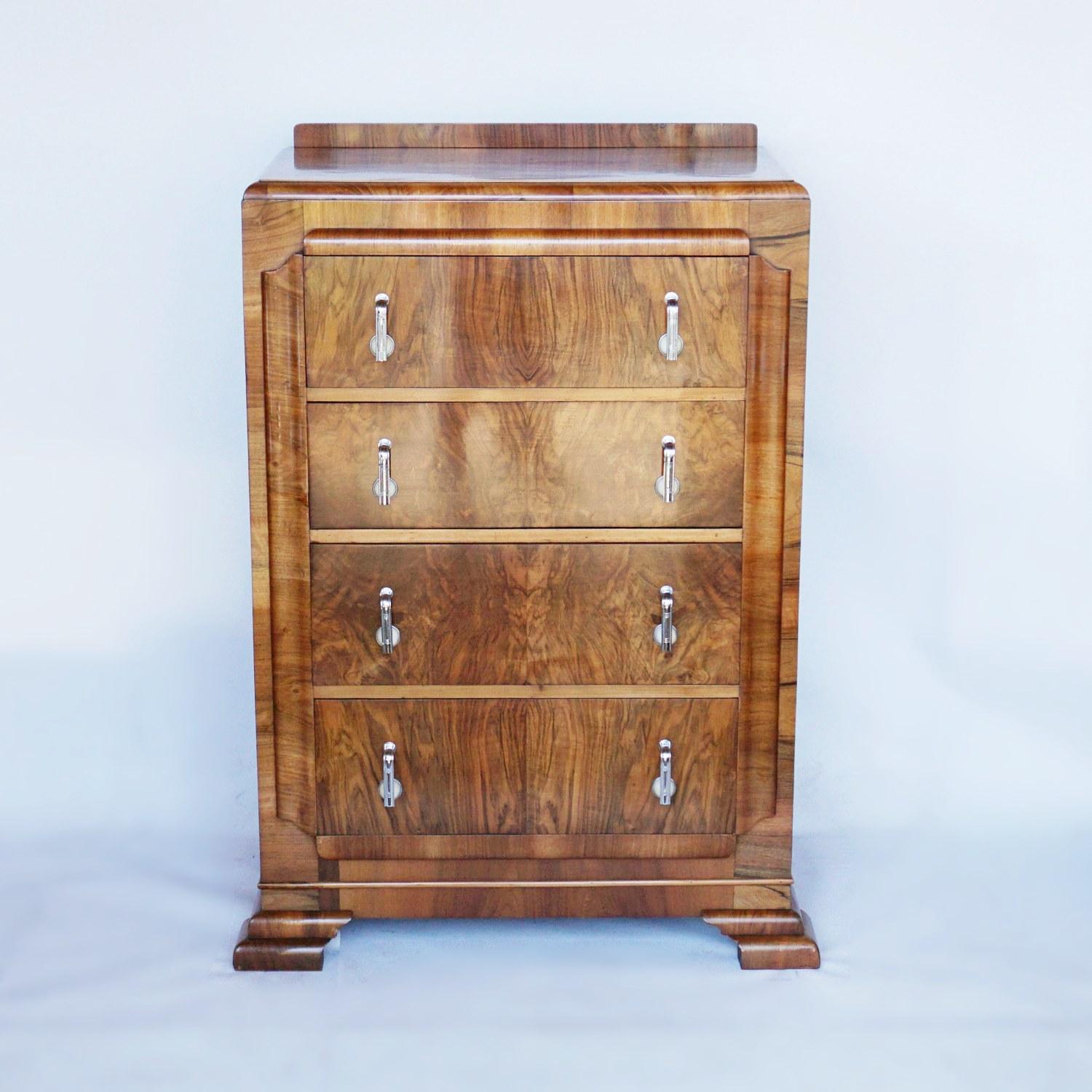 An Art Deco chest of drawers. Burr walnut and figured walnut veneered with original metal and bakelite handles.

Dimensions: H 114cm, W 75cm, D 47cm

Origin: English

Date: circa 1935

Item number: 0103211.
   