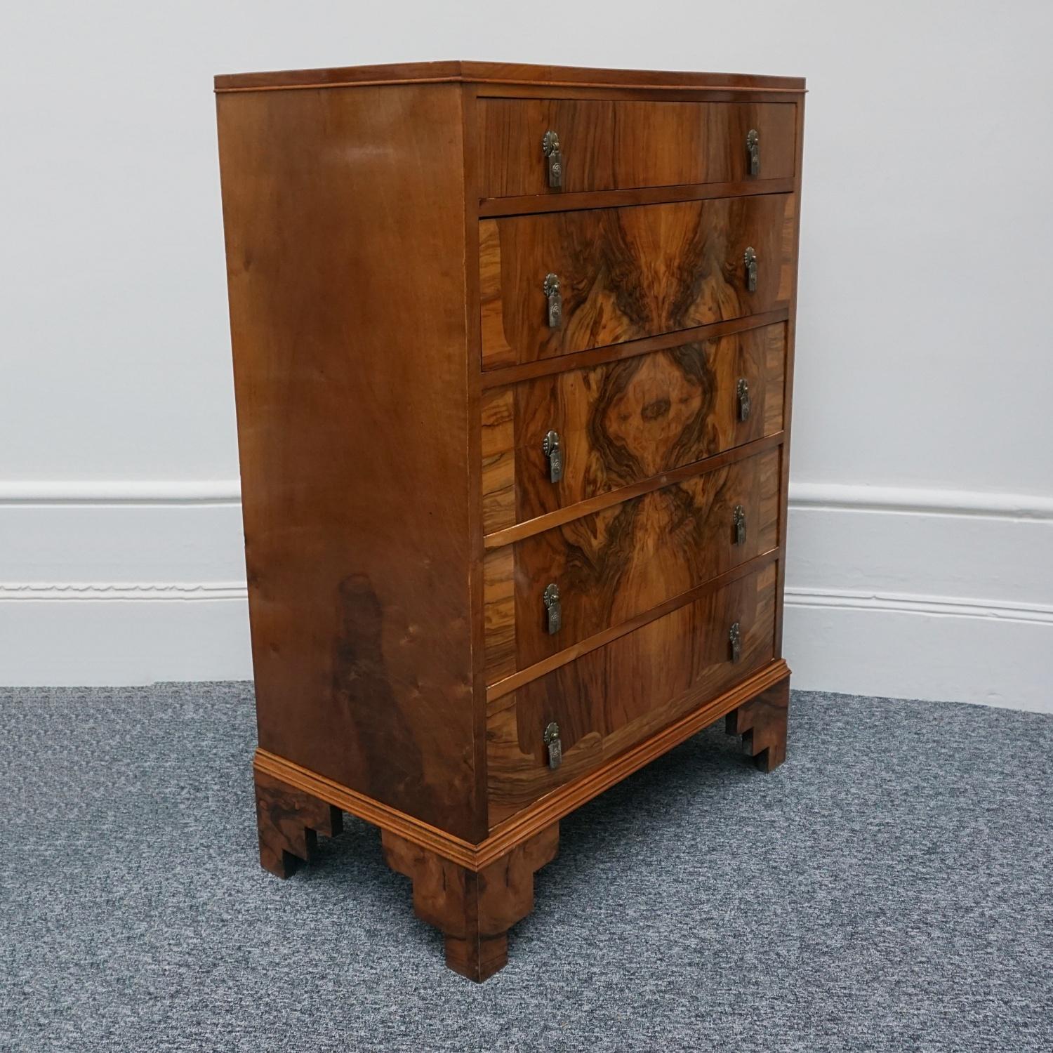 An Art Deco chest of drawers. Burr and figured walnut veneered throughout with original stepped legs and original metal handles. 

Dimensions: H 122.5cm W 85cm D 47cm 

Origin: English

Date: circa 1935 

Item Number: 1702231

All of our