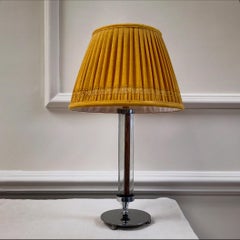 An art deco chrome and glass table lamp