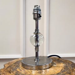 An art deco chrome and glass table lamp