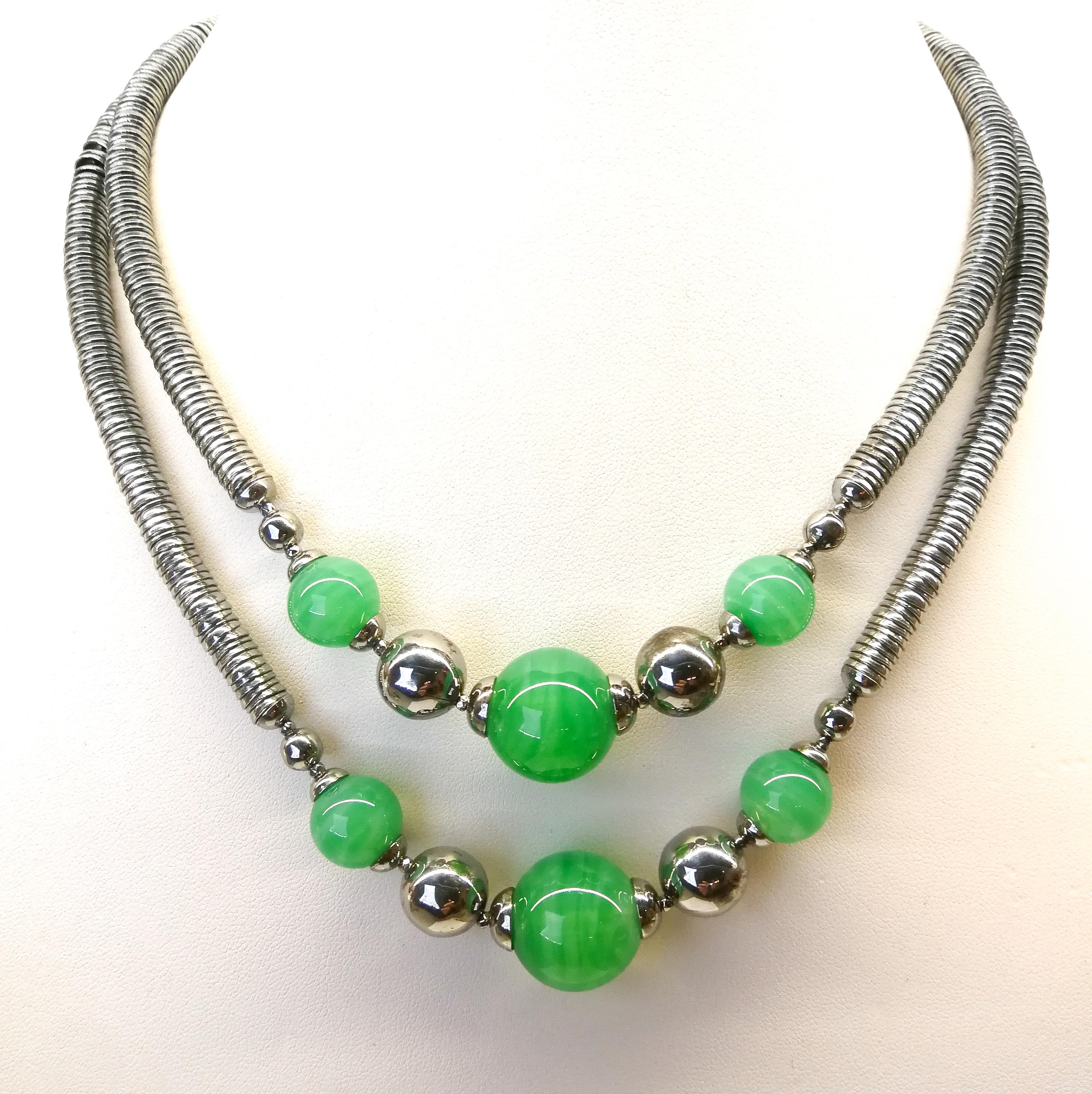A classic Art Deco chrome and glass bead two row necklace, made from small chrome metal 'cups', fitting one inside another , to create a very fluid and sensual necklace, in feel. Six ;marbled' green glass beads, of varying sizes, adorn the front of