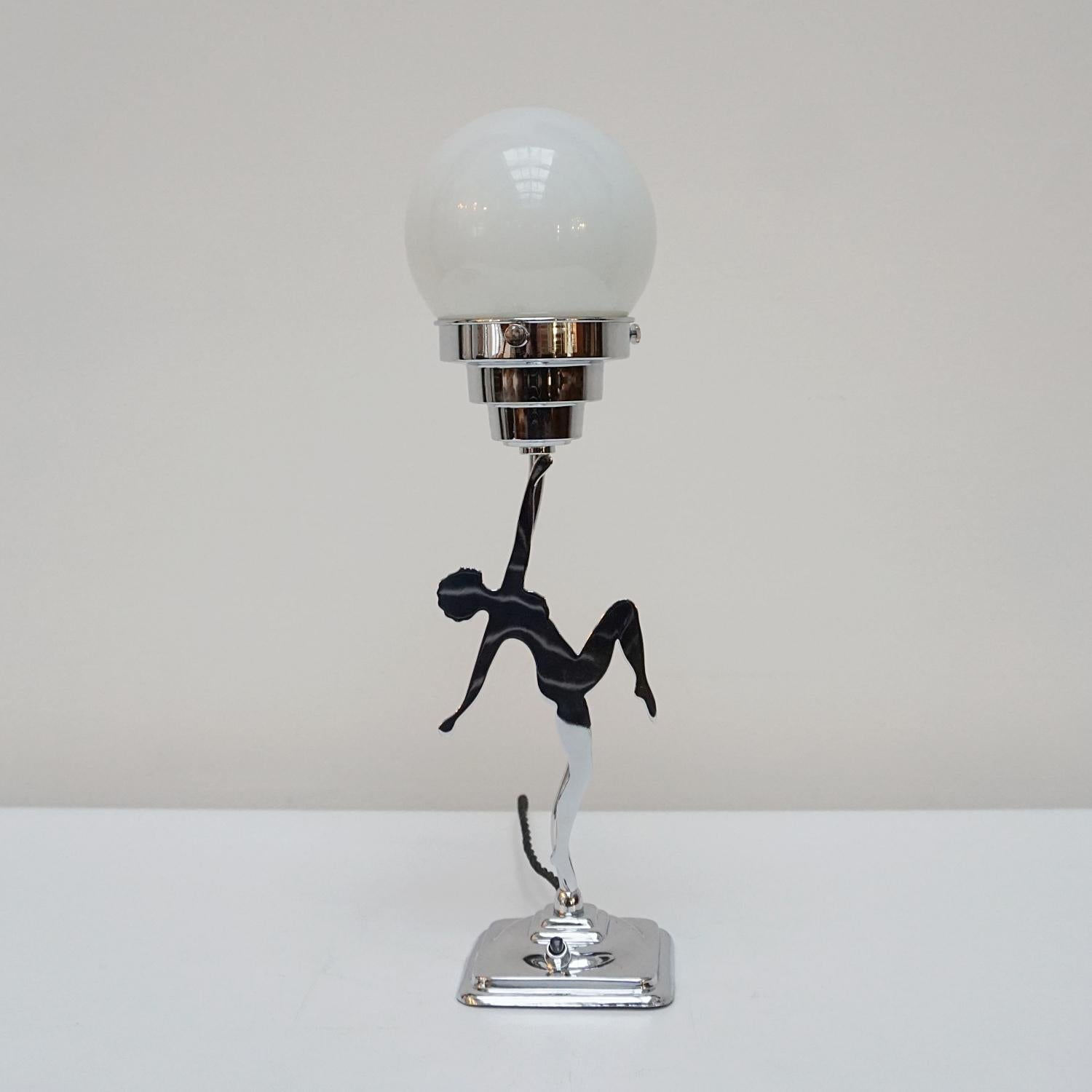 An original Art Deco table lamp. White glass globe shade with a chromed stylised dancer stem. 

Dimensions: H 40cm W 10cm

Origin: English 

Item Number: J314

All of our lighting is fully refurbished, re-wired, and re-chromed with some replacement