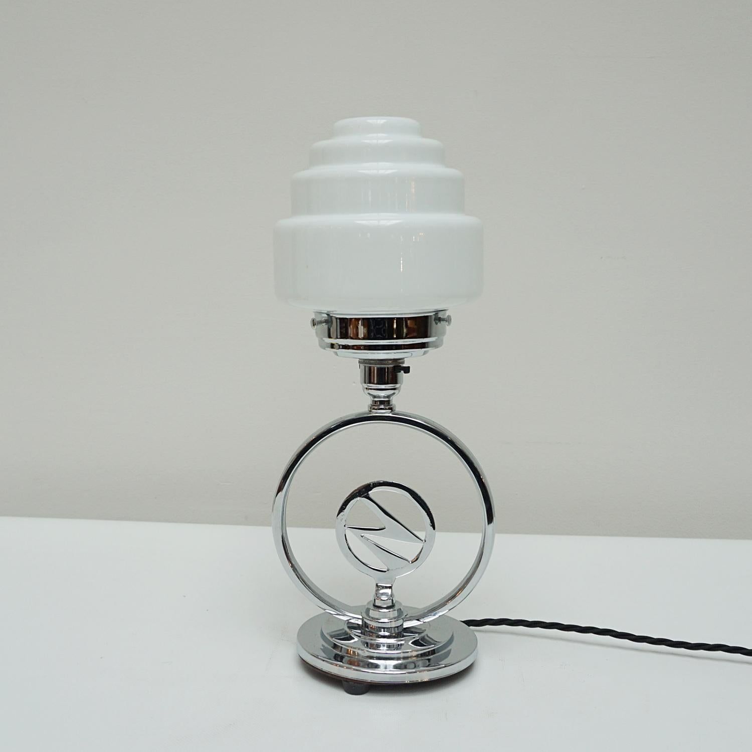 An Art Deco original table lamp. circular chromed stem centred around a lightning bolt. White glass globe shade.

Dimensions: H 37cm W 15cm 

Origin: English

Item Number: J316

All of our lighting is fully refurbished, re-wired, and re-chromed with