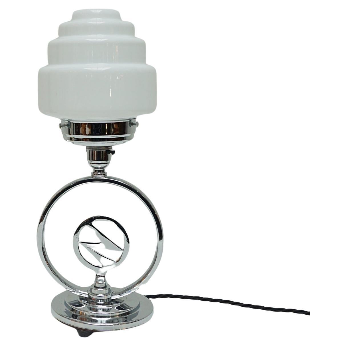 An Art Deco Chromed Lightning Bolt Table Lamp with Glass Globe Shade