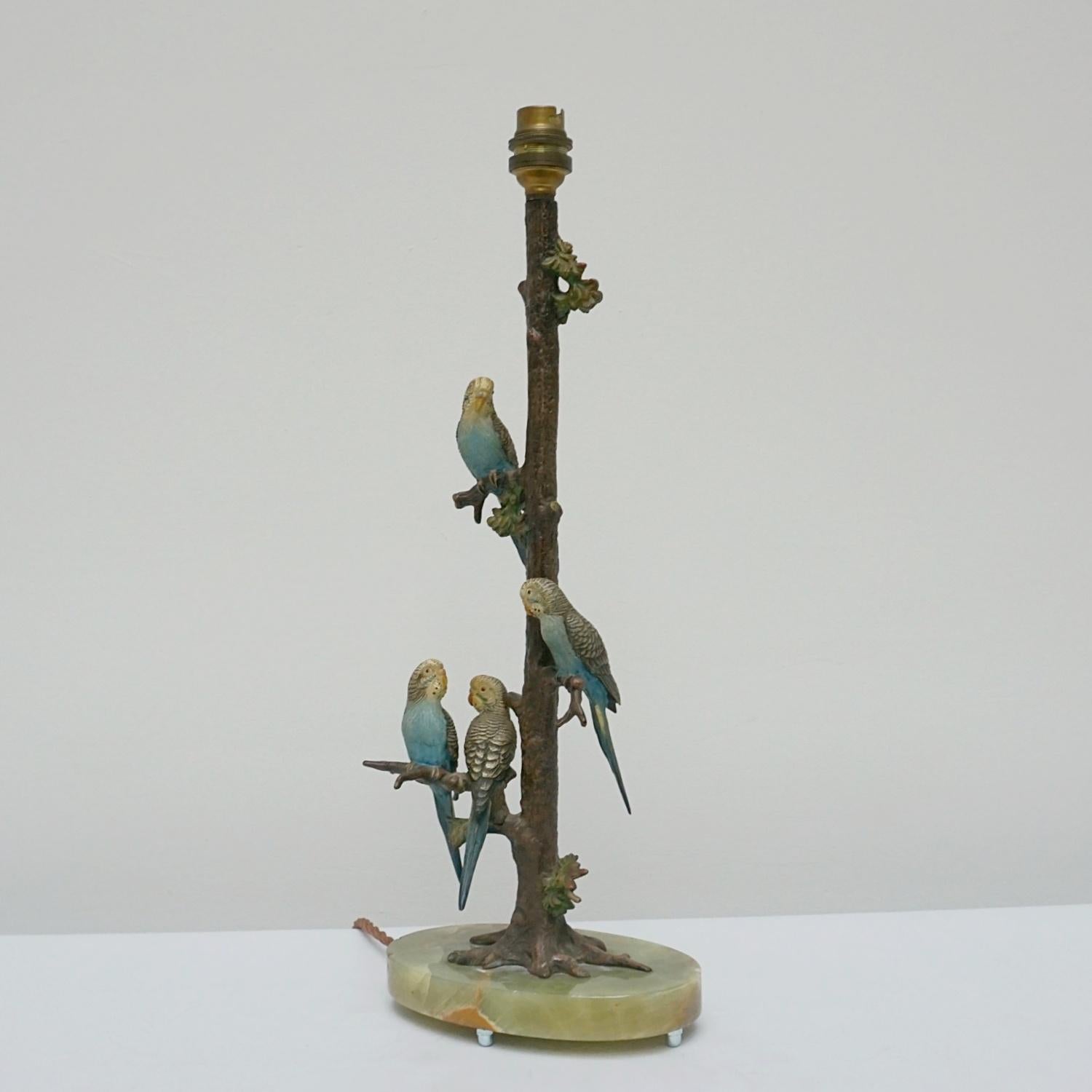 An Art Deco cold painted bronze budgerigar table lamp. Four sculpted bronze birds perching on leafy branches, set over an oval onyx base. 

Dimensions: H 45.5cm W 17.5cm D 11cm

Origin: Austria

Date: Circa, 1920

Item Number: