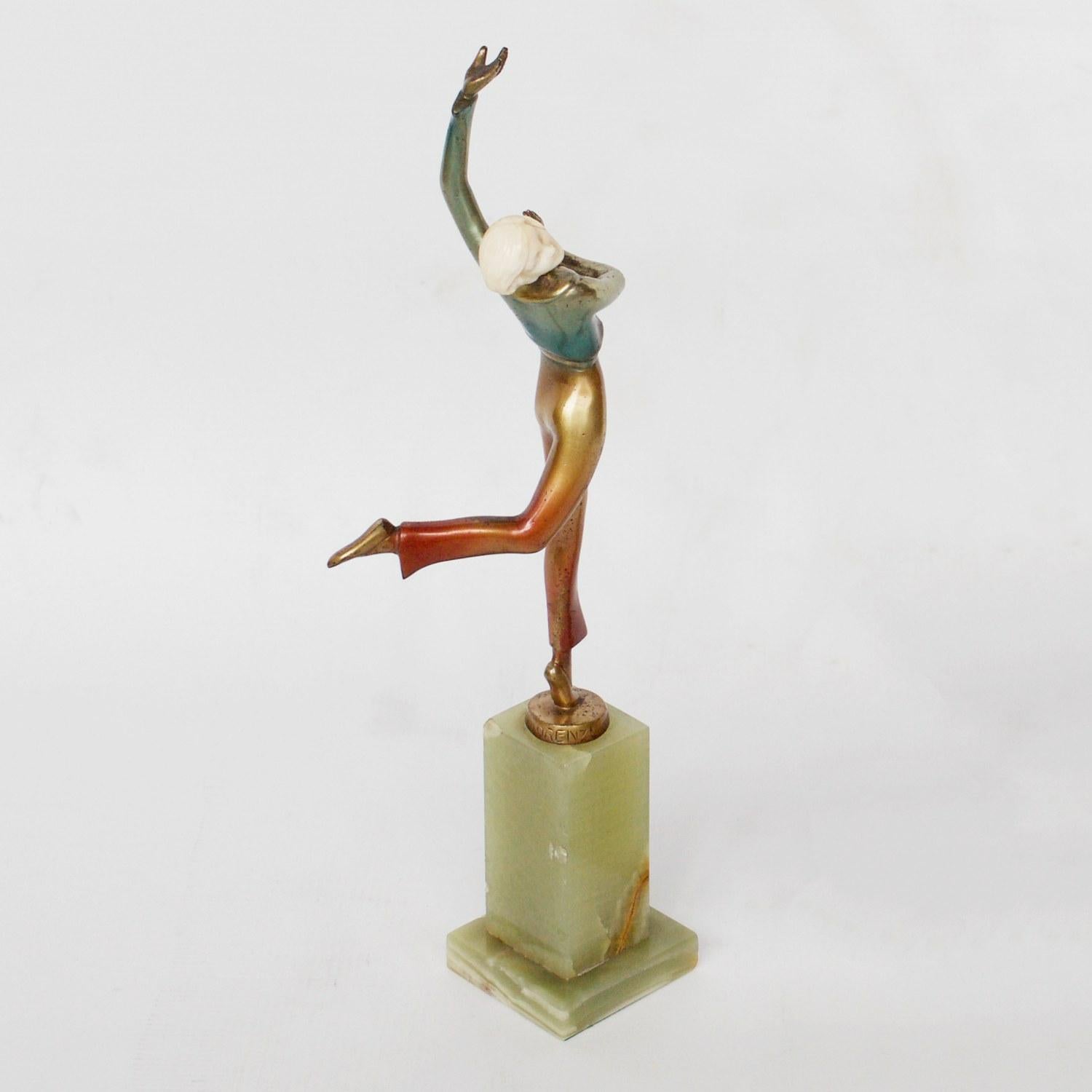 An Art Deco, cold painted bronze figure of an elegant dancer dancing the Charleston with arms out stretched in an extravagant pose. Hand carved ivory head, raised on a green onyx base. Original enamel patination. 

Signed Lorenzl to