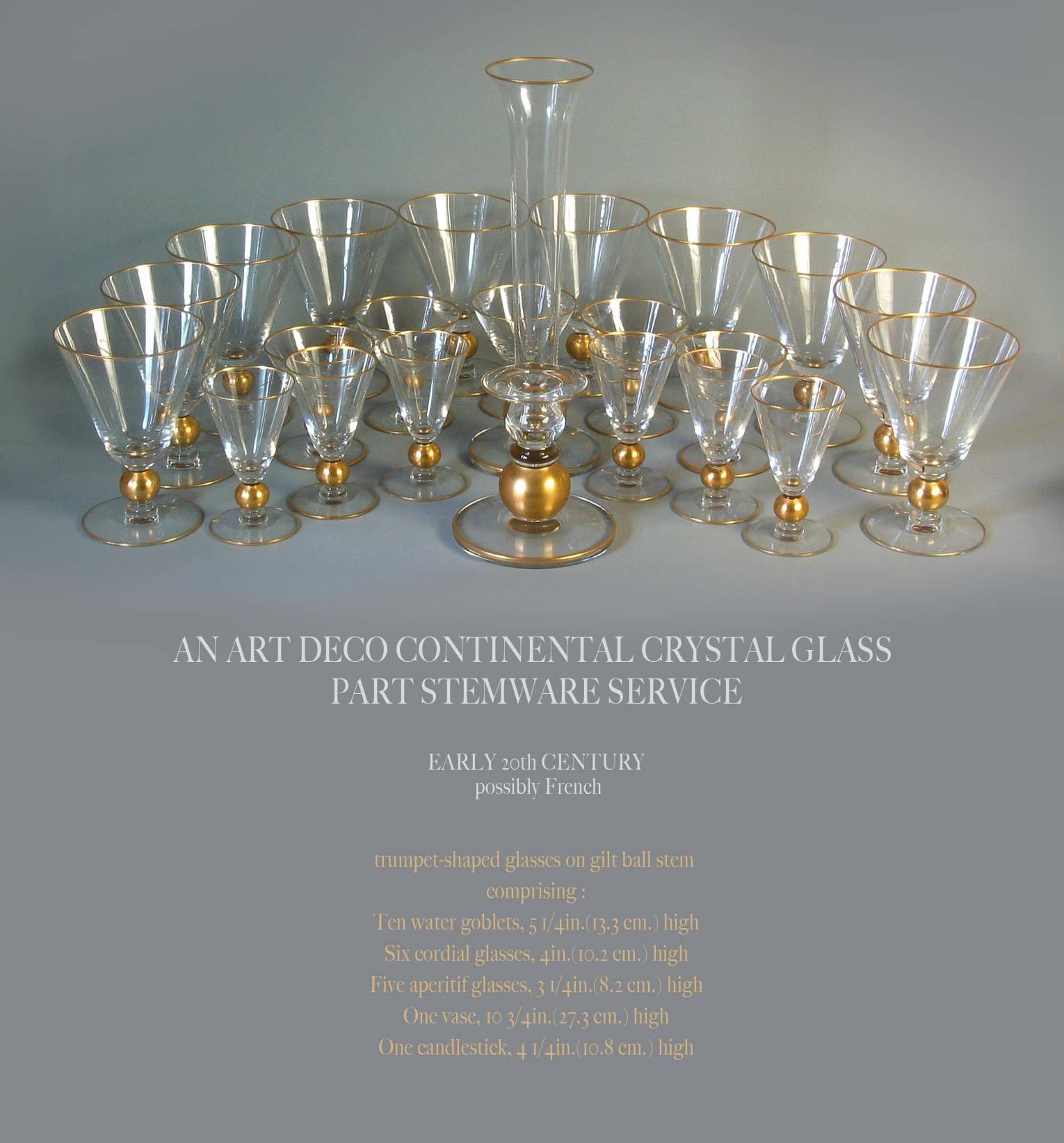 An Art Deco continental crystal glass part stemware service, early 20th century, Possibly French.
The partial service consists of 23 pieces in total as follows,
Trumpet shaped glasses on gilt ball stem comprising of:
Ten water goblets, 5