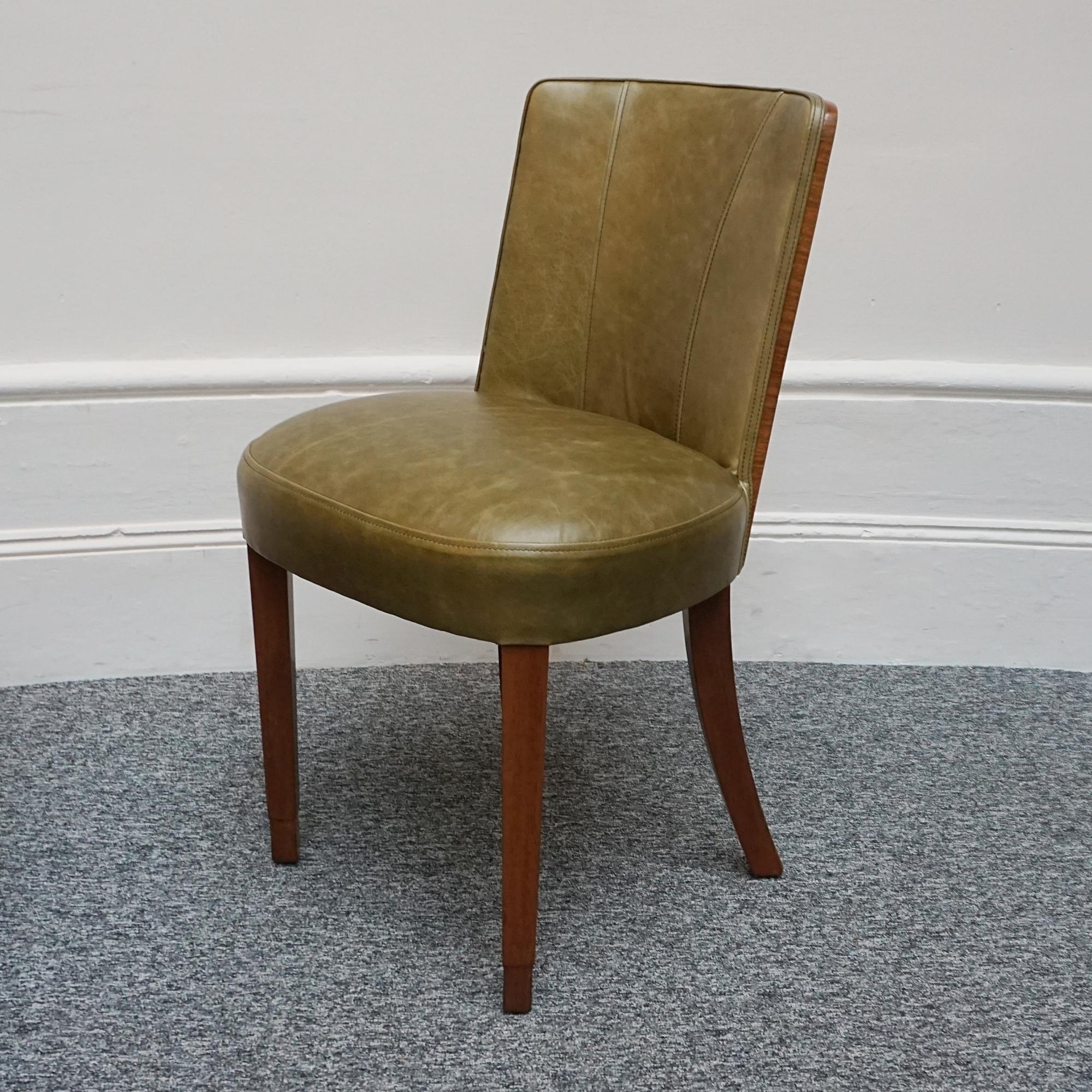 An Art Deco side chair. Olive green re-upholstery with contrasting figured walnut backs and solid walnut legs. 

All of our furniture is extensively polished and restored where necessary to the highest standards.

