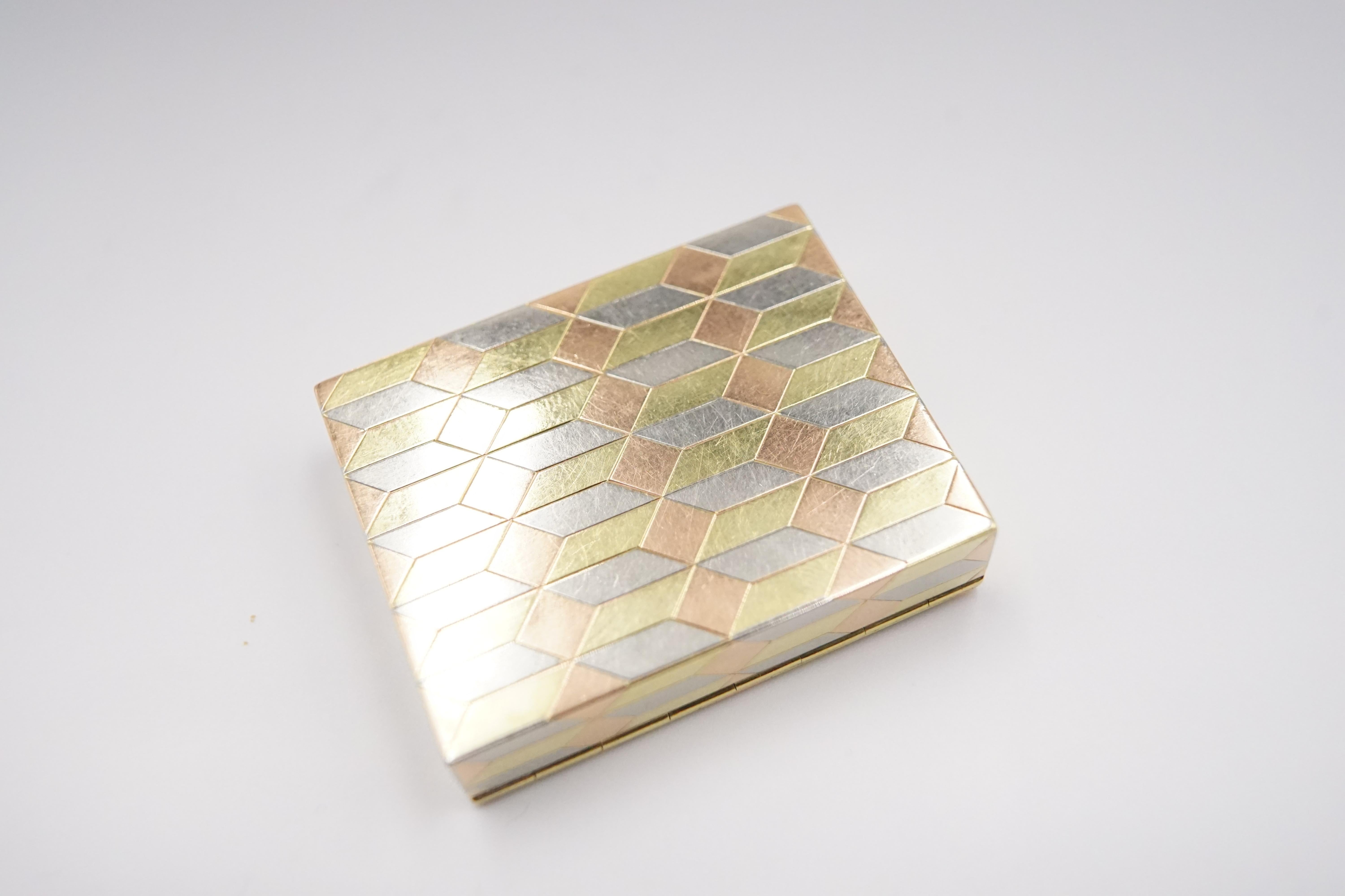 An Art Deco 14ct Tri-Colour Gold Vanity Case by Cartier in original leather pocket.

Cartier used its tri-colour gold for the cuboid geometric pattern throughout the case each colour gold forms a visible face of the cuboid. The craftsmanship of this