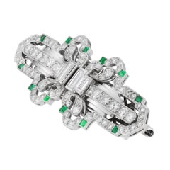 An Art Deco diamond and emerald double clip brooch